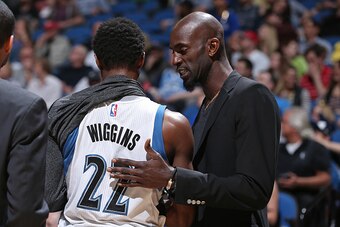 MINNEAPOLIS, MN - APRIL 13:  Kevin Garnett #21 talks with teammate Andrew Wiggins #22 of the Minnesota Timberwolves during the game against the New Orleans Pelicans on April 13, 2015 at Target Center in Minneapolis, Minnesota. NOTE TO USER: User expressly