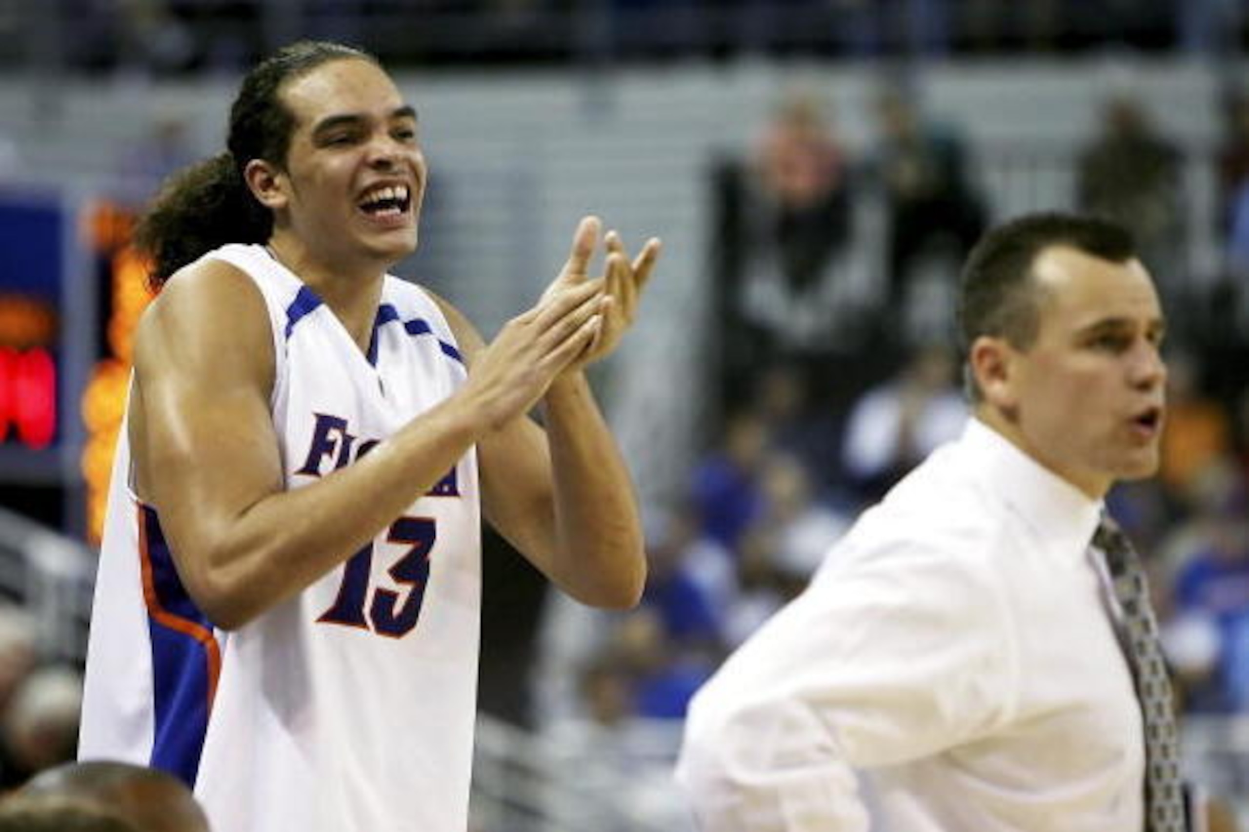 GAINESVILLE, FL - NOVEMBER 10:  Joakim Noah #13 of the University of Florida Gators celebrates behind head coach Billy Donovan from the bench in the second half against the Samford Bulldogs at the O'Connell Center on November 10, 2006 in Gainesville, Flor