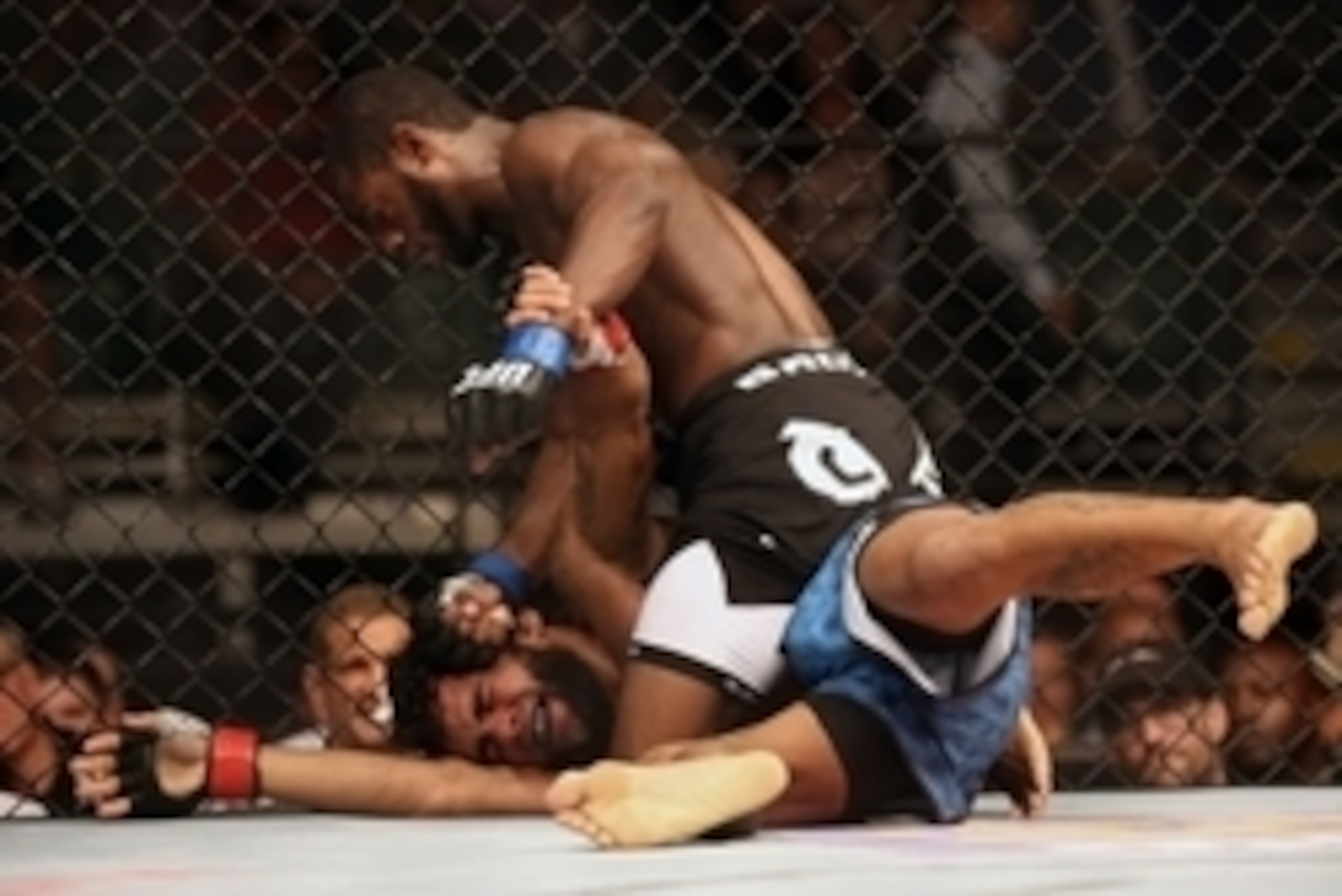 Jul 16, 2014; Atlantic City, NJ, USA; Aljamain Sterling (blue gloves) lands a punch on Hugo Viana (red gloves) during a bantamweight bout at Revel Casino. Mandatory Credit: Bill Streicher-USA TODAY Sports