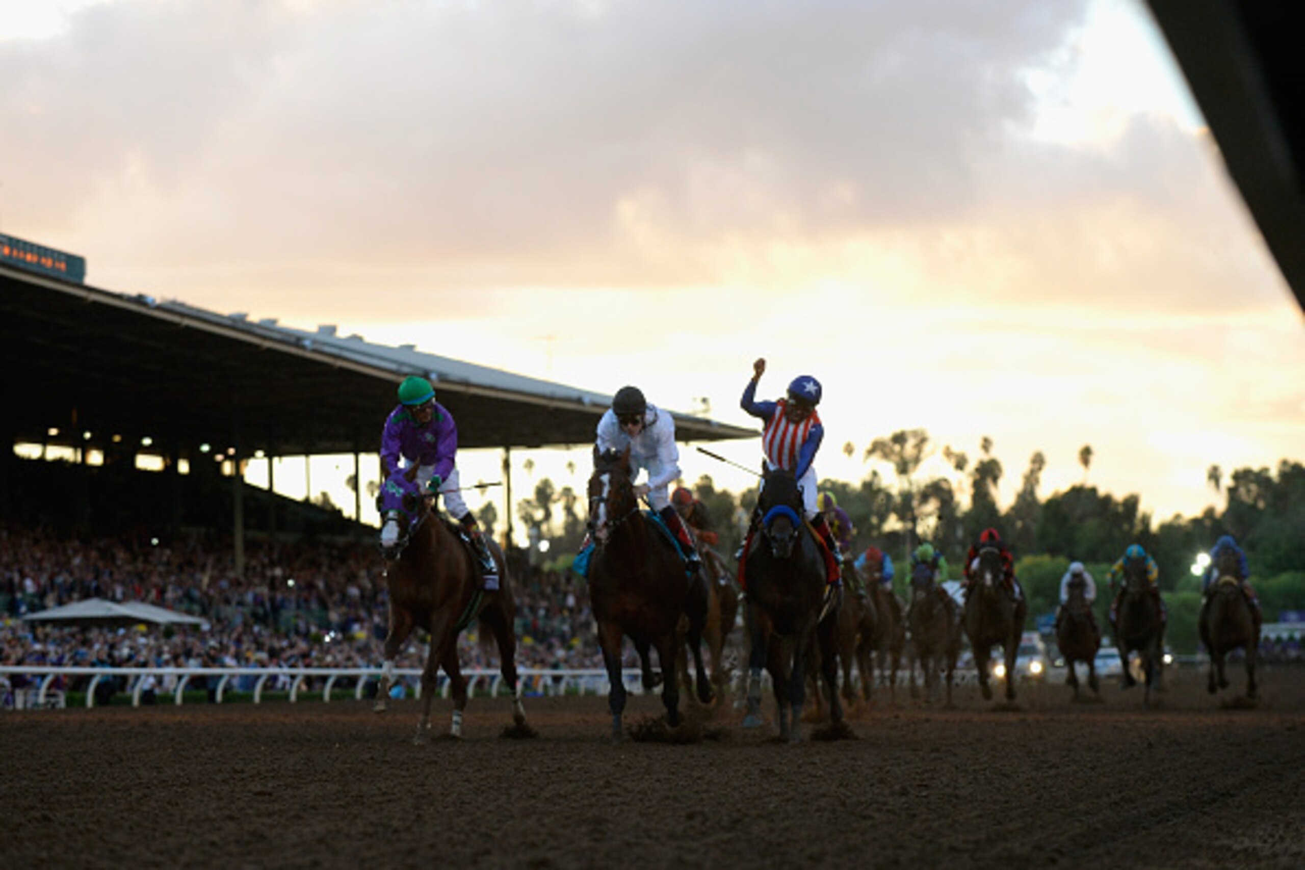 ARCADIA, CA - NOVEMBER 01:  Jockey Martin Garcia atop Bayern celebrates winning the 2014 Breeders' Cup Classic ahead of second place finisher jockey Jamie Spencer atop Toast of New York and third place finisher jocket Victor Espinoza atop California Chrom