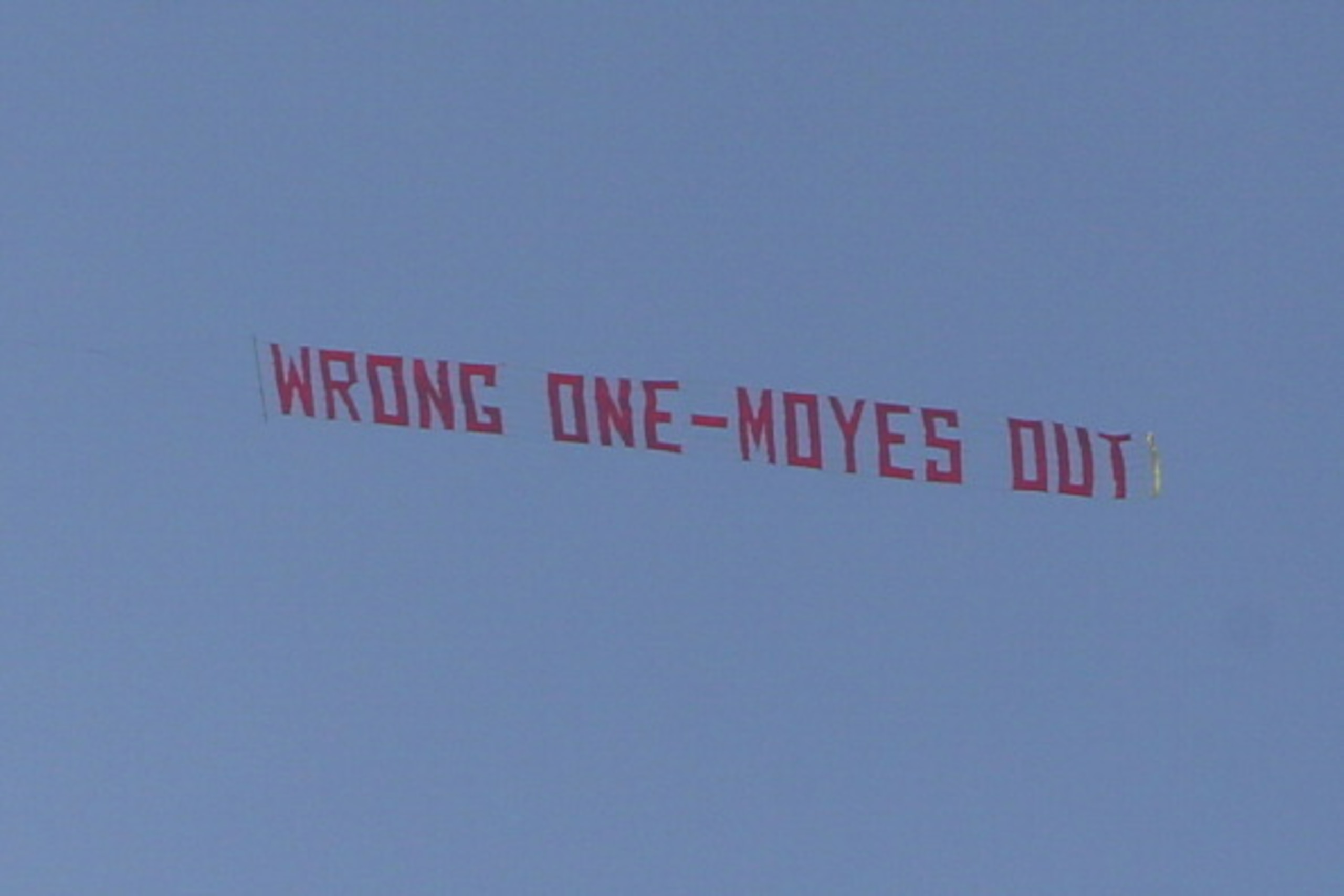 MANCHESTER, ENGLAND - MARCH 29:  A plane flies overhead with a banner criticising Manchester United Manager David Moyes during the Barclays Premier League match between Manchester United and Aston Villa at Old Trafford on March 29, 2014 in Manchester, Eng