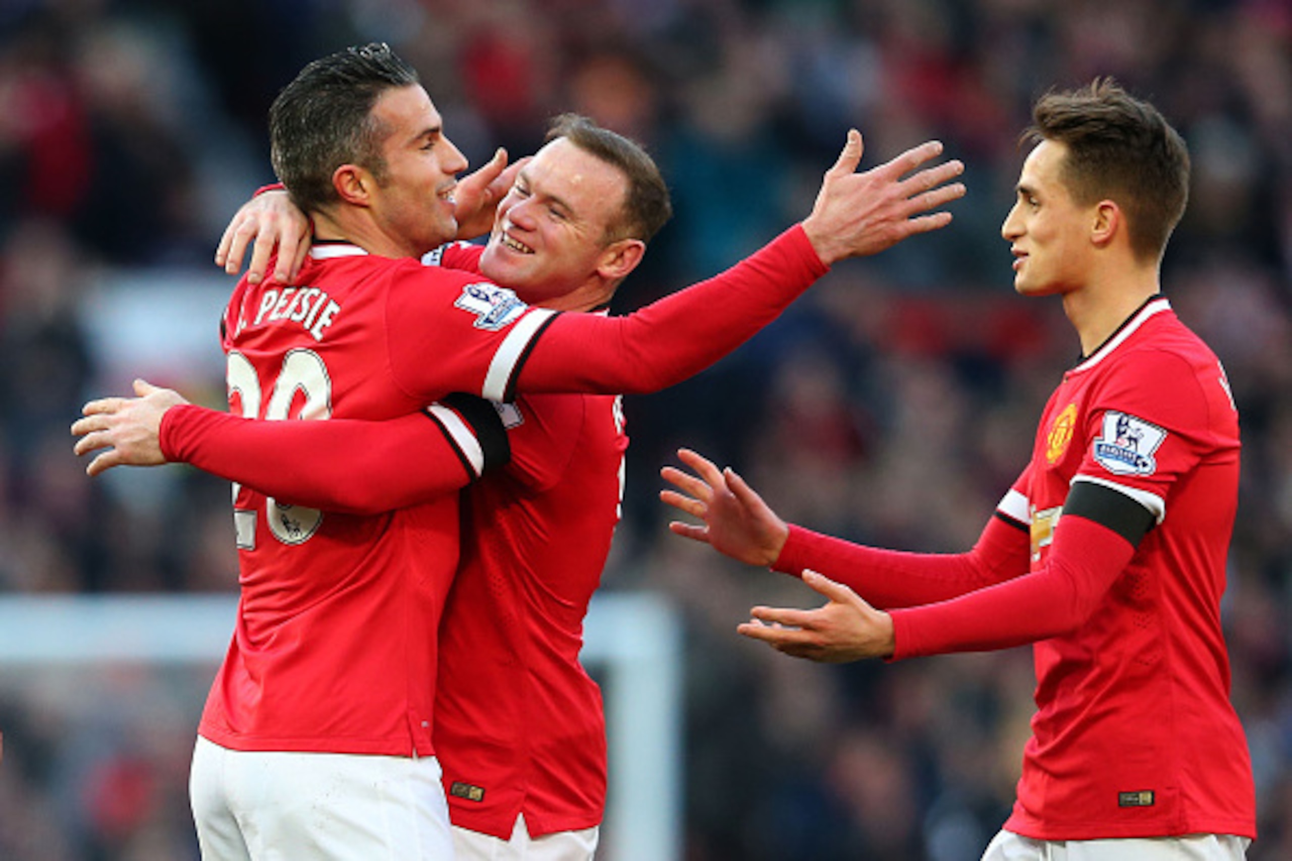 MANCHESTER, ENGLAND - JANUARY 31:  (L-R) Robin van Persie of Manchester United is congratulated by teammates Wayne Rooney and Adnan Januzaj after scoring his team's first goal during the Barclays Premier League match between Manchester United and Leiceste