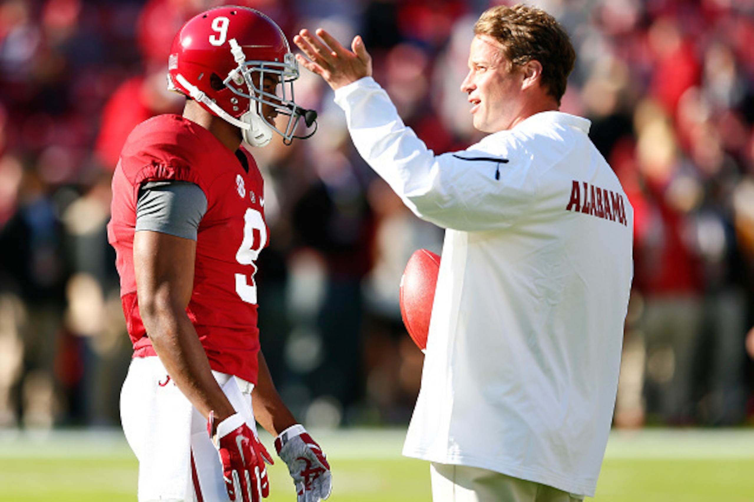 TUSCALOOSA, AL - NOVEMBER 15:  Offensive Coordinator Lane Kiffin of the Alabama Crimson Tide converses with Amari Cooper #9 prior to facing the Mississippi State Bulldogs at Bryant-Denny Stadium on November 15, 2014 in Tuscaloosa, Alabama.  (Photo by Kevi