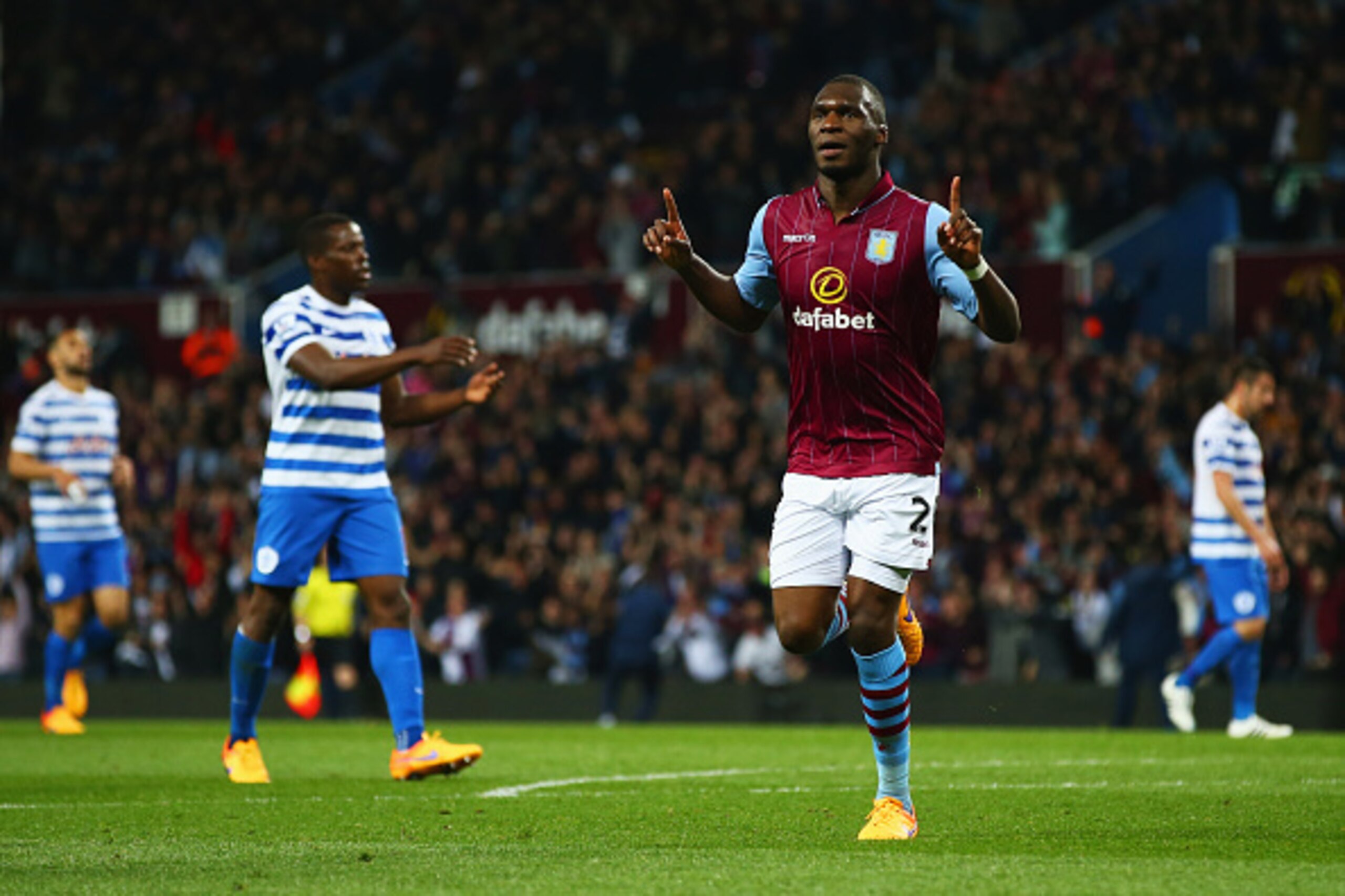 BIRMINGHAM, ENGLAND - APRIL 07:  Despair for QPR players as Christian Benteke of Aston Villa (20) celebrates as he scores their second goal during the Barclays Premier League match between Aston Villa and Queens Park Rangers at Villa Park on April 7, 2015