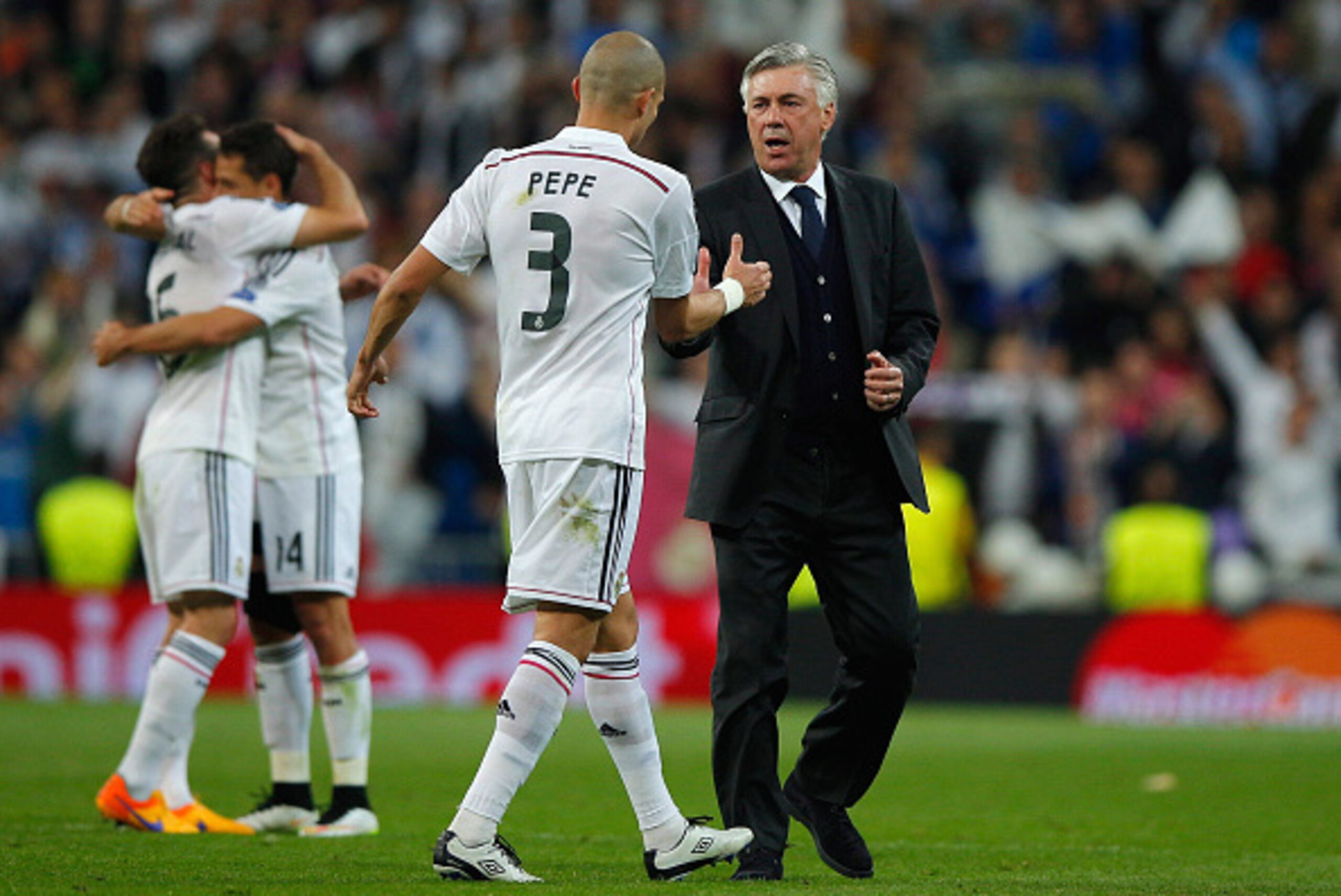 MADRID, SPAIN - APRIL 22:  Pepe of Real Madrid CF celebrates victory with Carlo Ancelotti head coach of Real Madrid CF after the UEFA Champions League quarter-final second leg match between Real Madrid CF and Club Atletico de Madrid at Bernabeu on April 2