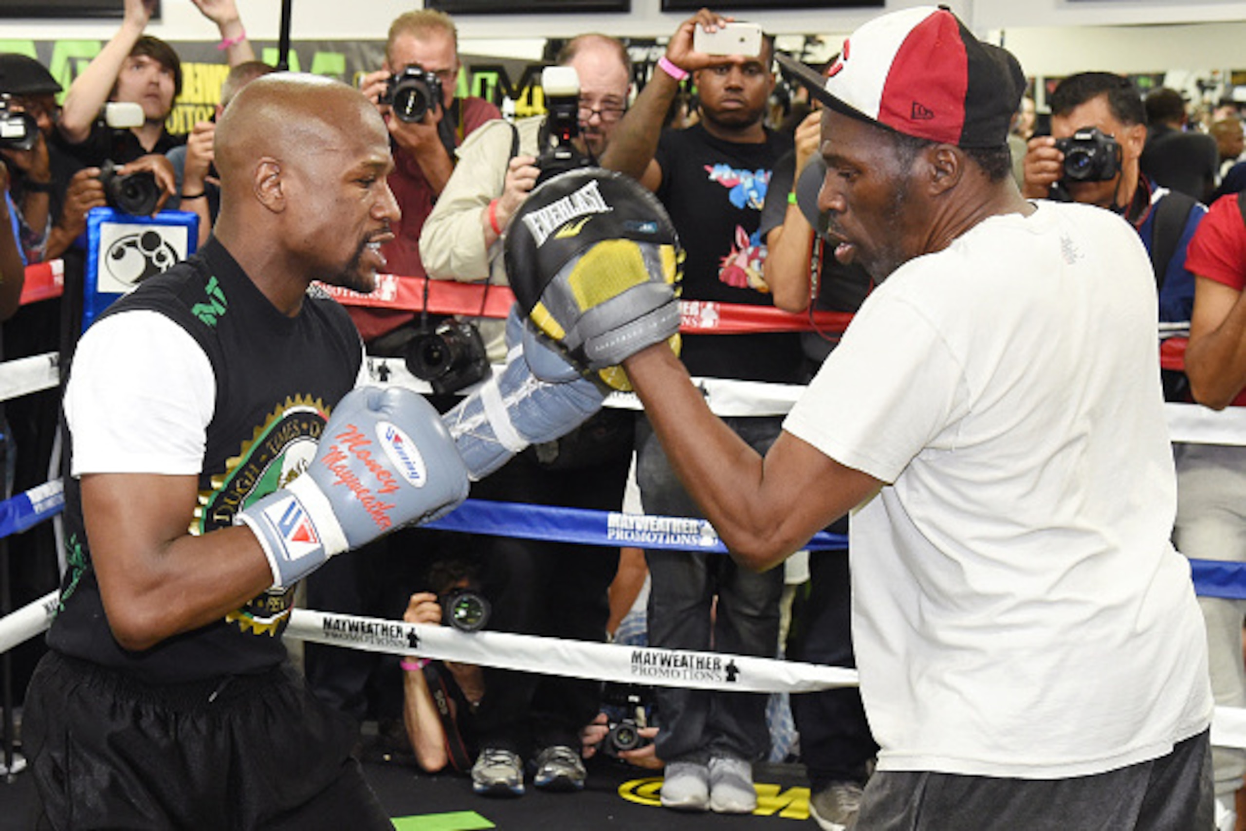 LAS VEGAS, NV - APRIL 14:  WBC/WBA welterweight champion Floyd Mayweather Jr. (L) works out with his uncle Roger Mayweather at the Mayweather Boxing Club on April 14, 2015 in Las Vegas, Nevada. Mayweather Jr. will face WBO welterweight champion Manny Pacq