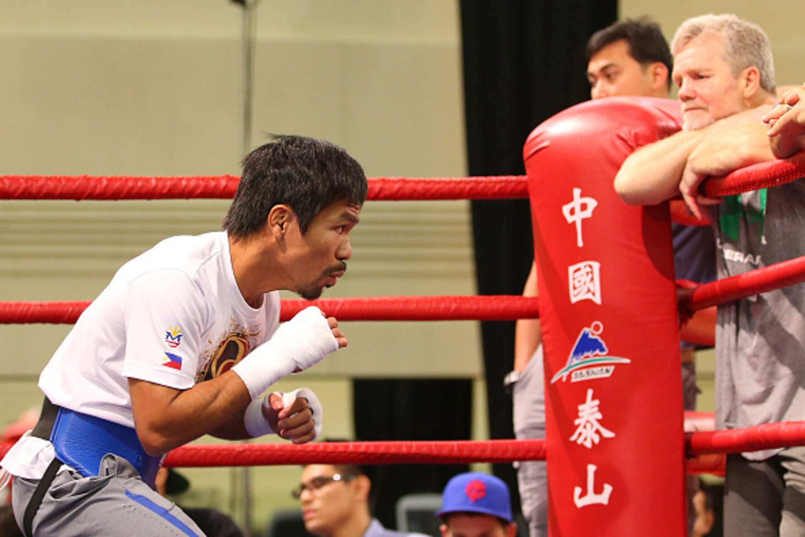 MACAU - NOVEMBER 21:  Manny Pacquiao trains while trainer Freddie Roach looks on during a workout session at The Venetianon November 21, 2014 in Macau, Macau.  (Photo by Chris Hyde/Getty Images)