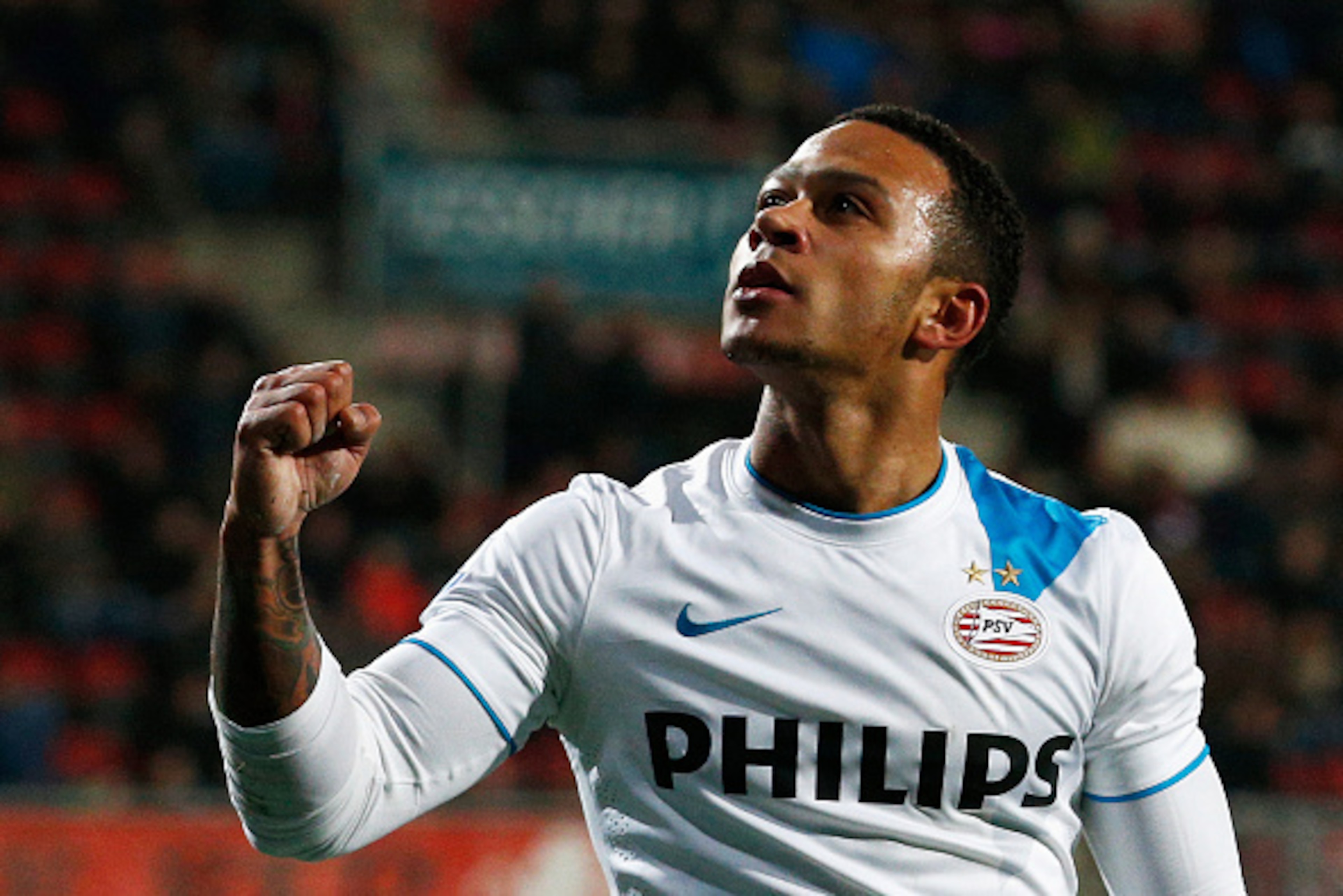 ENSCHEDE, NETHERLANDS - APRIL 04:  Memphis Depay of PSV celebrates after he scores the fifth goal of the game for his team during the Dutch Eredivisie match between FC Twente and PSV Eindhoven held at De Grolsch Veste Stadium on April 4, 2015 in Enschede,
