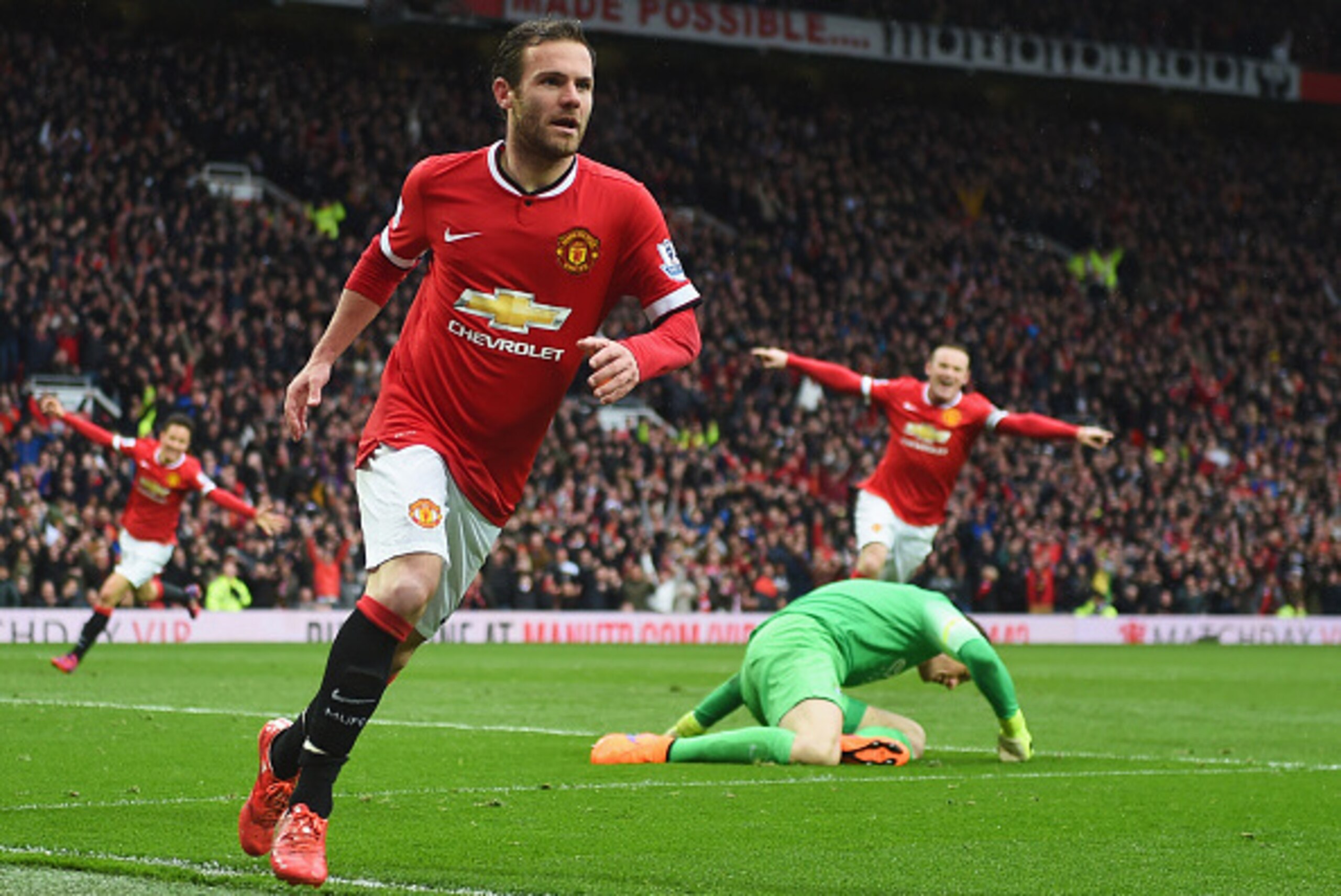 MANCHESTER, ENGLAND - APRIL 12:  Juan Mata of Manchester United celebrates as he beats Joe Hart of Manchester City to score their third goal during the Barclays Premier League match between Manchester United and Manchester City at Old Trafford on April 12