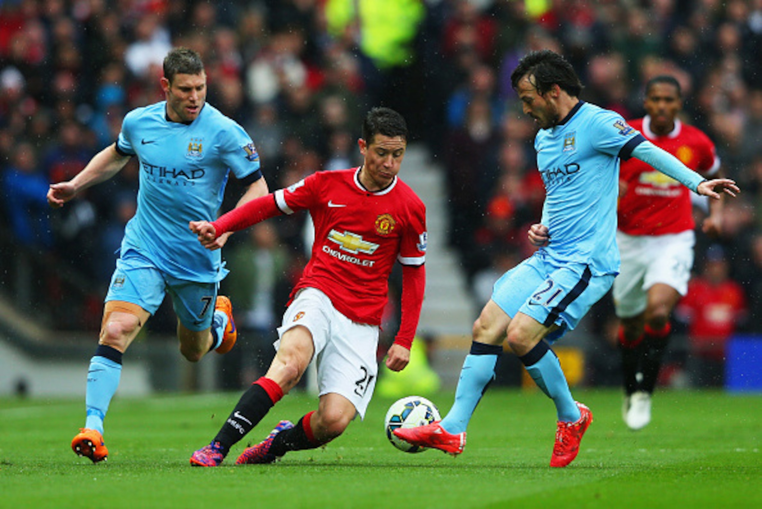 MANCHESTER, ENGLAND - APRIL 12:  Ander Herrera of Manchester United (C) takes on James Milner (L) and David Silva of Manchester City (R) during the Barclays Premier League match between Manchester United and Manchester City at Old Trafford on April 12, 20