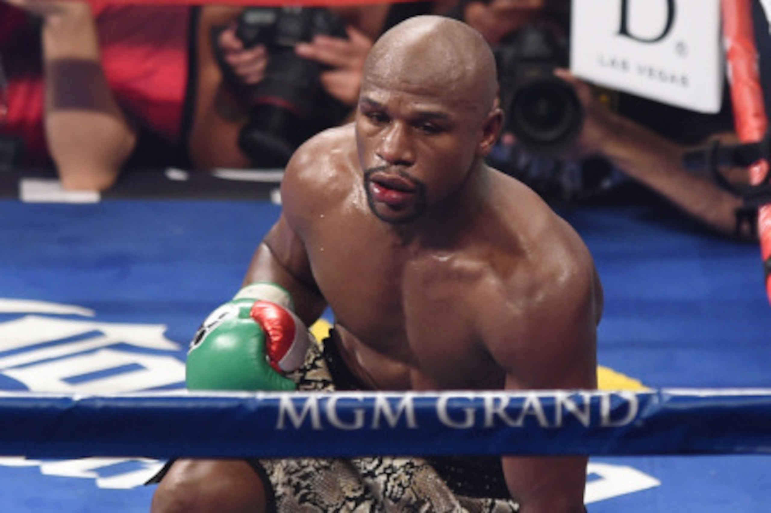 LAS VEGAS, NV - SEPTEMBER 13:  Floyd Mayweather Jr. gets up from the canvas after being pushed down by Marcos Maidana in the 10th round of their WBC/WBA welterweight title fight at the MGM Grand Garden Arena on September 13, 2014 in Las Vegas, Nevada. Mai