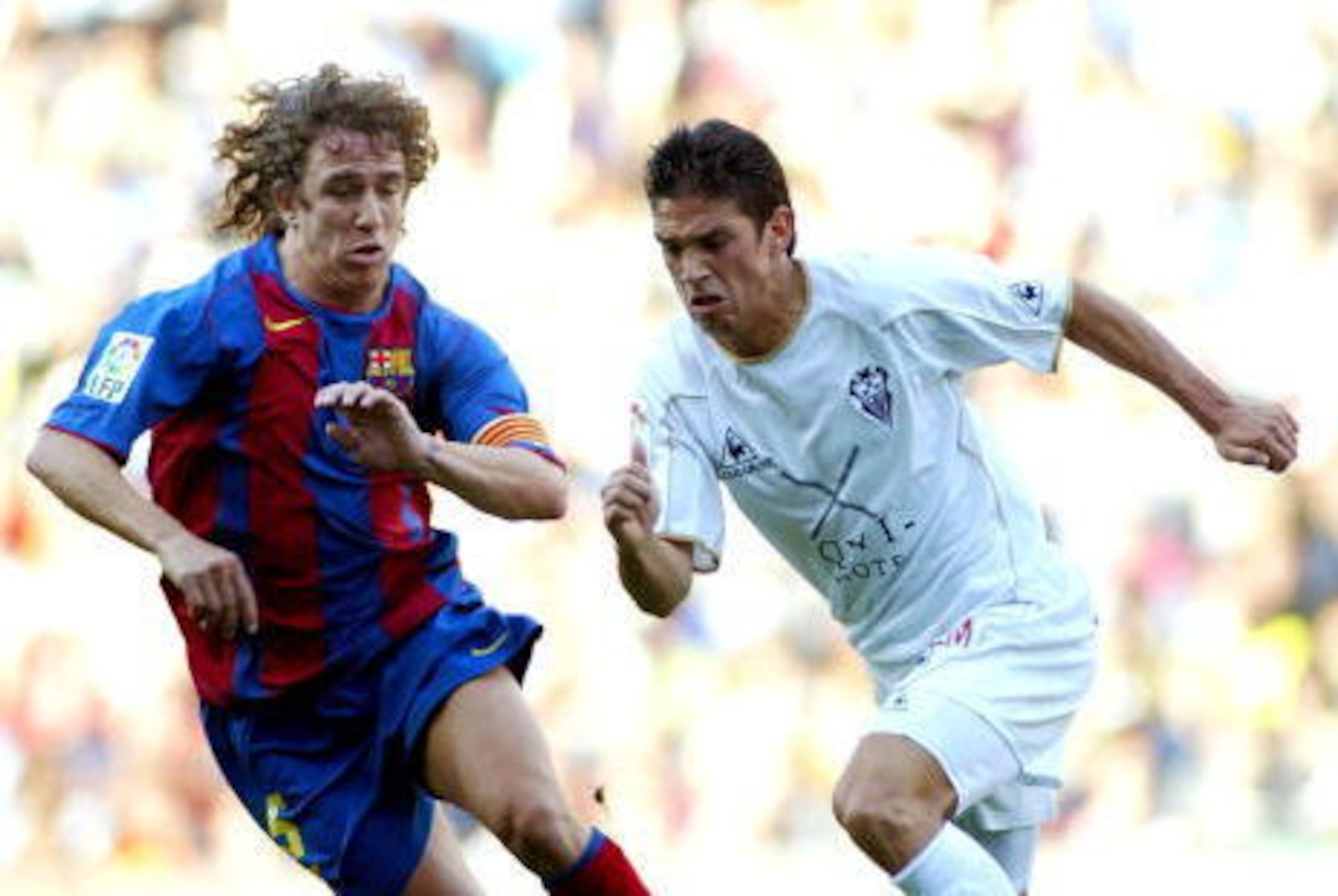 BARCELONA, SPAIN - MAY 1:  Carles Puyol of FC Barcelona challenges Francisco of Albacete during the La Liga match between FC Barcelona and Albacete on May 1, 2005 at Nou Camp Stadium in Barcelona, Spain.  (Photo by Luis Bagu/Getty Images)