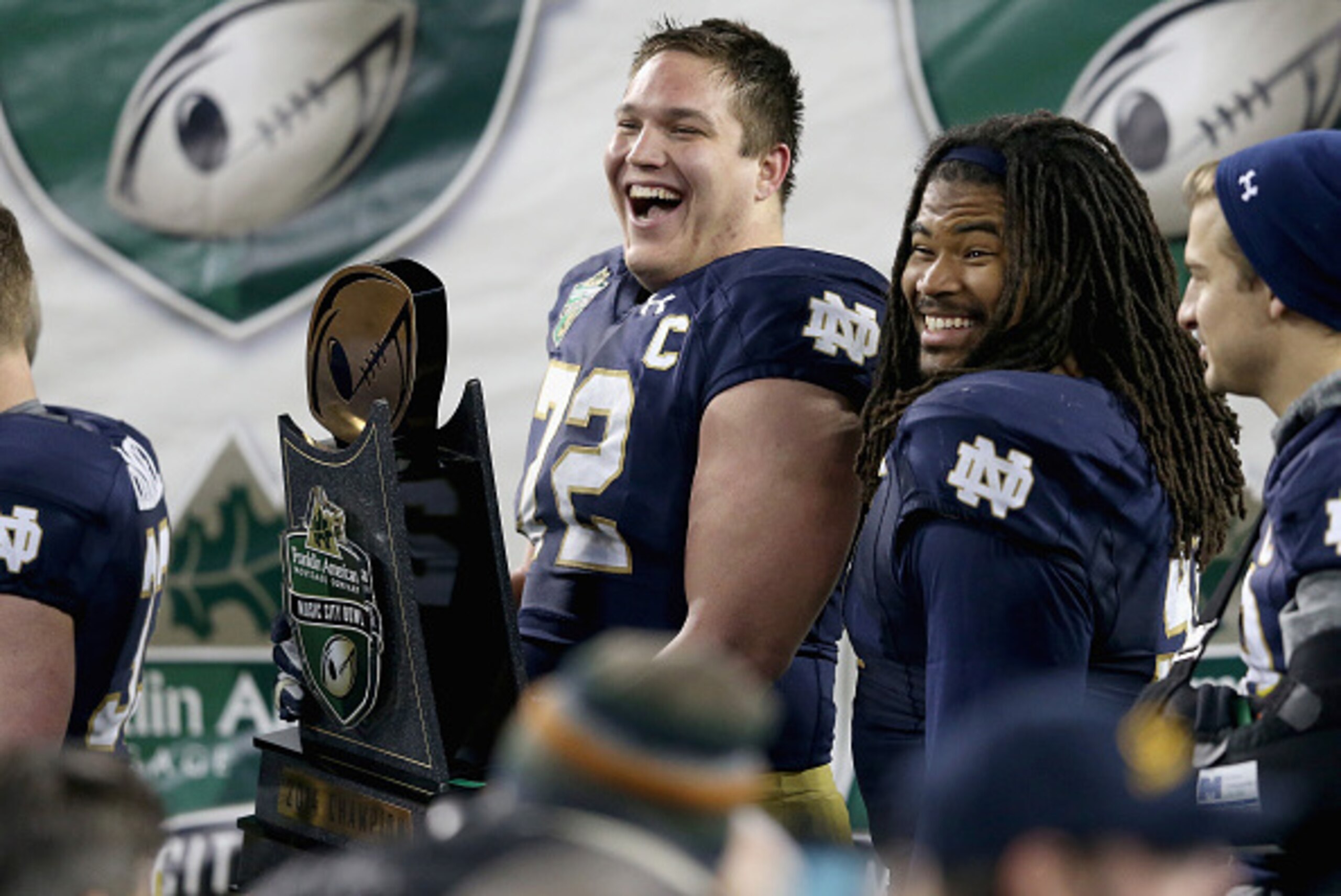 NASHVILLE, TN - DECEMBER 30:  Nick Martin #72 of the Notre Dame Fighting Irish celebrates while holding the champions trophy after the Irish beat the LSU Tigers 31-28 in the Franklin American Mortgage Music City Bowl at LP Field on December 30, 2014 in Na