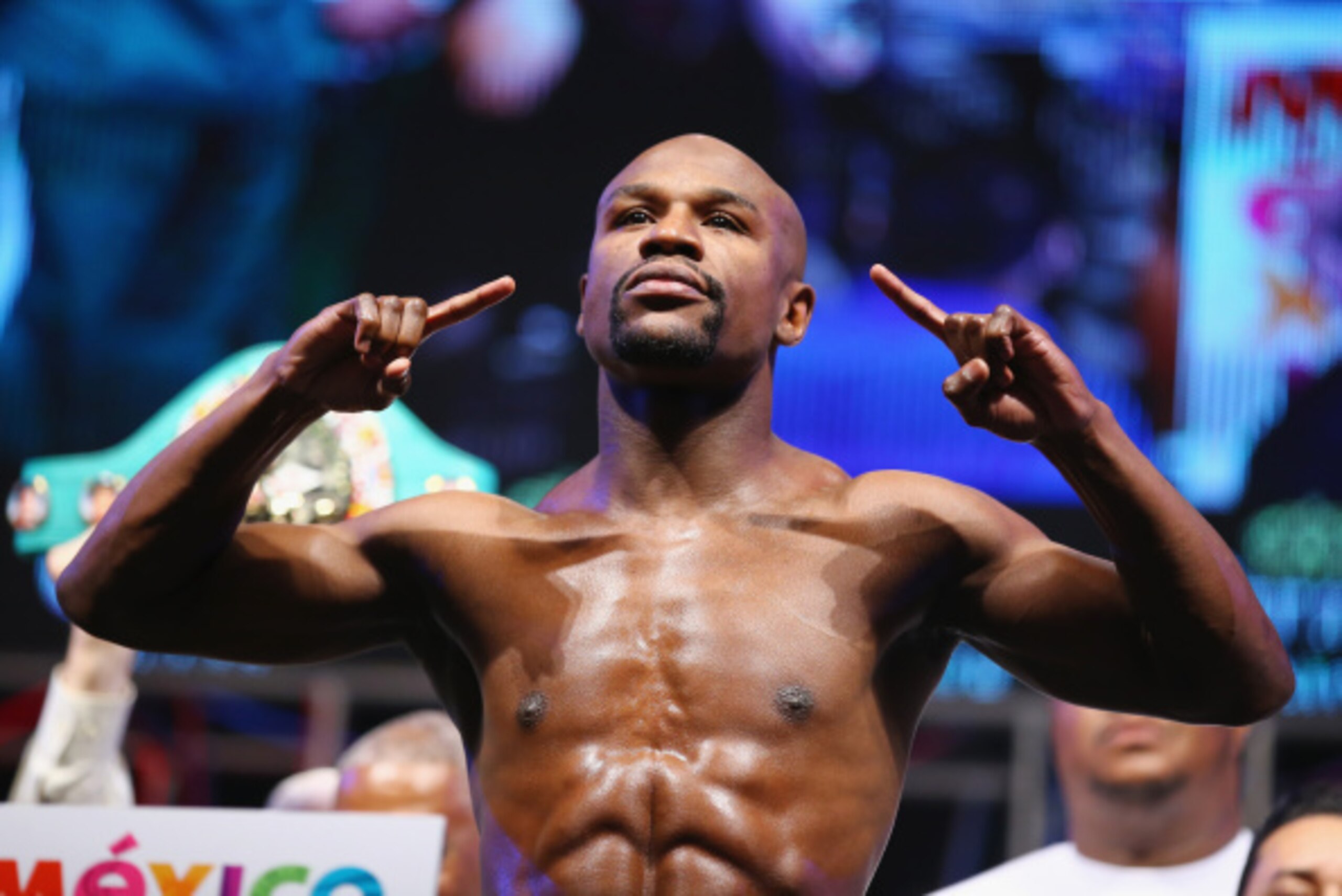 LAS VEGAS, NV - SEPTEMBER 12:  WBC/WBA welterweight champion Floyd Mayweather Jr. poses on the scale during his official weigh-in at the MGM Grand Garden Arena on September 12, 2014 in Las Vegas, Nevada. Mayweather Jr. will defend his titles against Marco