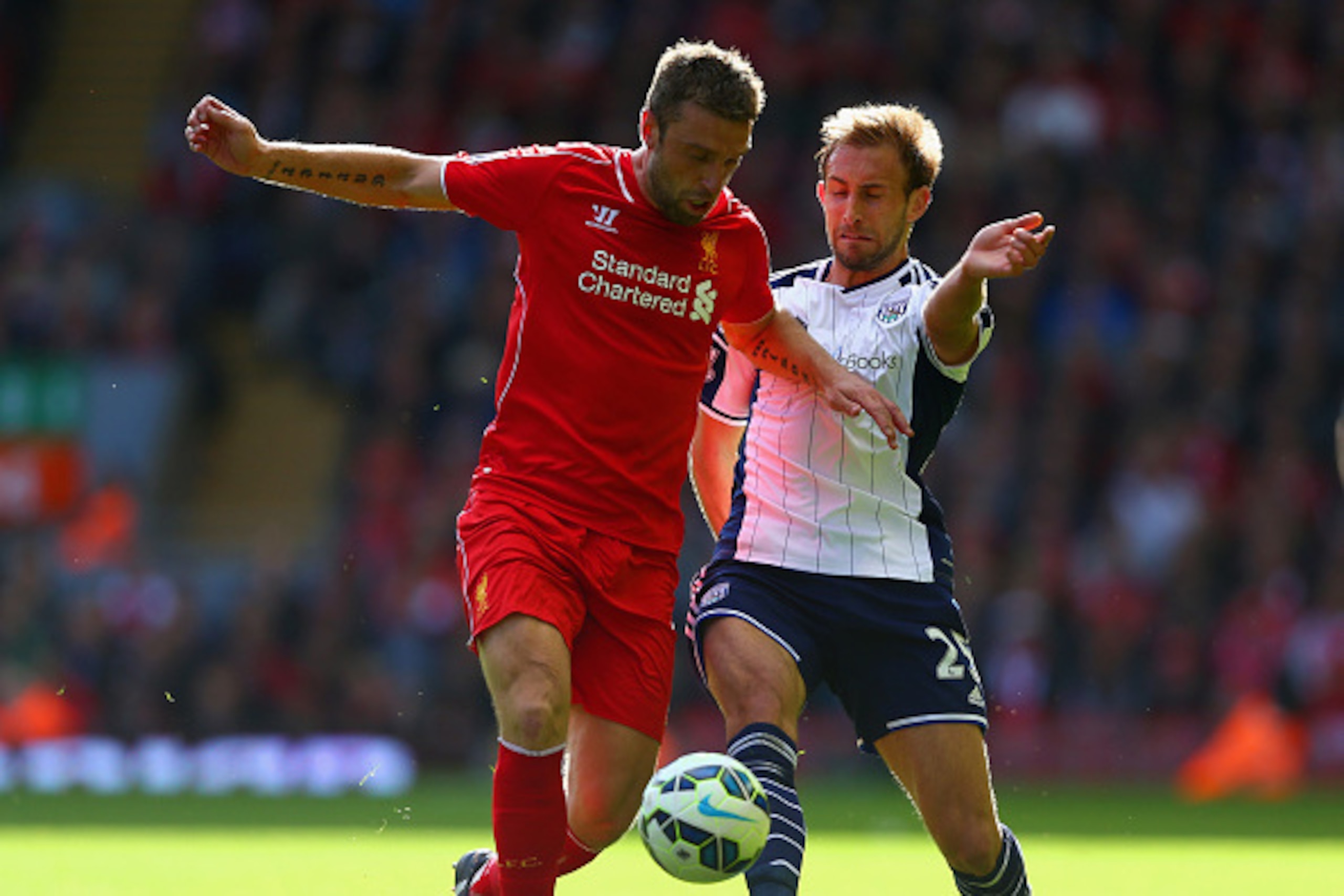 LIVERPOOL, ENGLAND - OCTOBER 04:  Rickie Lambert of Liverpool and Craig Dawson of West Brom battle for the ball during the Barclays Premier League match between Liverpool and West Bromwich Albion at Anfield on October 4, 2014 in Liverpool, England.  (Phot