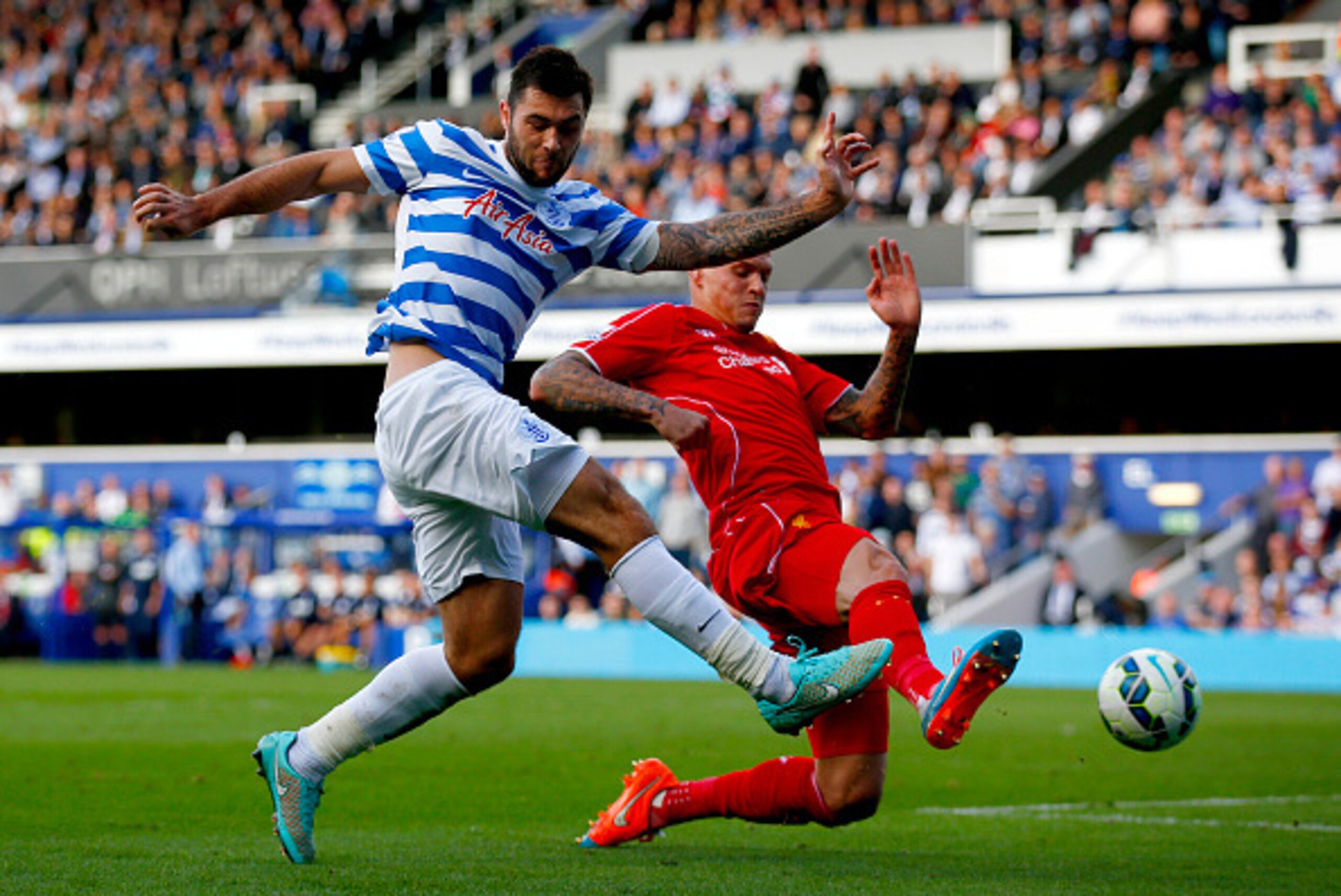 LONDON, ENGLAND - OCTOBER 19:  Martin Skrtel of Liverpool blocks a cross from Charlie Austin of QPR during the Barclays Premier League match between Queens Park Rangers and Liverpool at Loftus Road on October 19, 2014 in London, England.  (Photo by Clive 