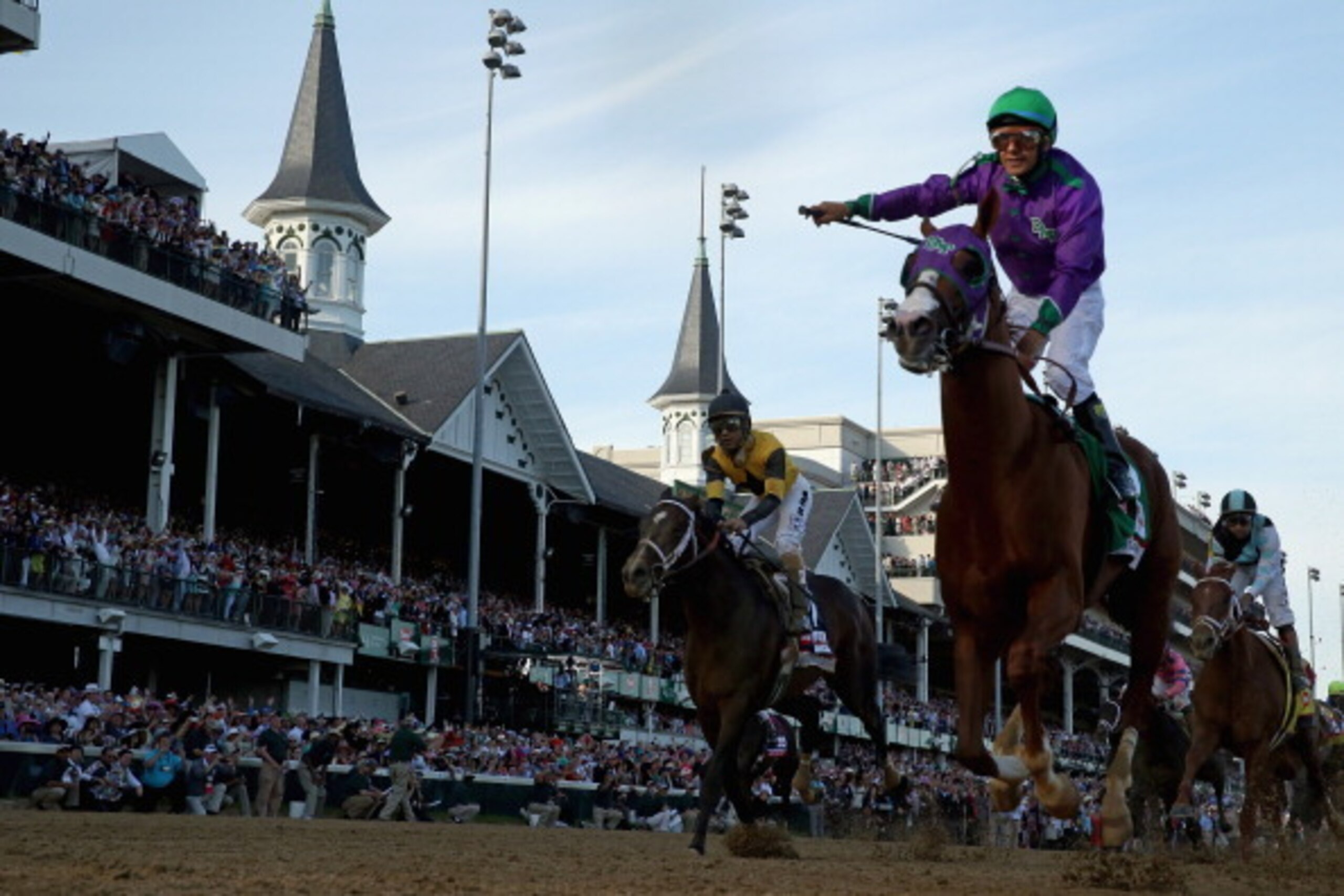 LOUISVILLE, KY - MAY 03:  Jockey Victor Espinoza celebrates atop of California Chrome #5 after crossing the finish line to win the 140th running of the Kentucky Derby at Churchill Downs on May 3, 2014 in Louisville, Kentucky.  (Photo by Rob Carr/Getty Ima