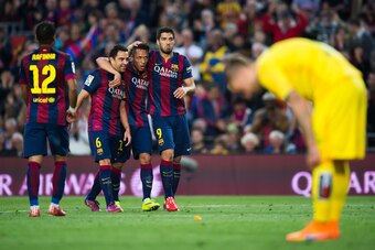 BARCELONA, SPAIN - APRIL 28: Xavi Hernandez (2nd L) and Adriano Correia (3rd L) of FC Barcelona celebrate with their teammate Luis Suarez (C) after he scored his team's fifth goal during the La Liga match between FC Barcelona and Getafe CF at Camp Nou on