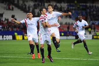 SEVILLE, SPAIN - APRIL 16:  Denis Suarez of Sevilla (17) celebrates with Grzegorz Krychowiak (4) as he scores their second goal during the UEFA Europa League Quarter Final first leg match between FC Sevilla and FC Zenit at Estadio Ramon Sanchez Pizjuan on