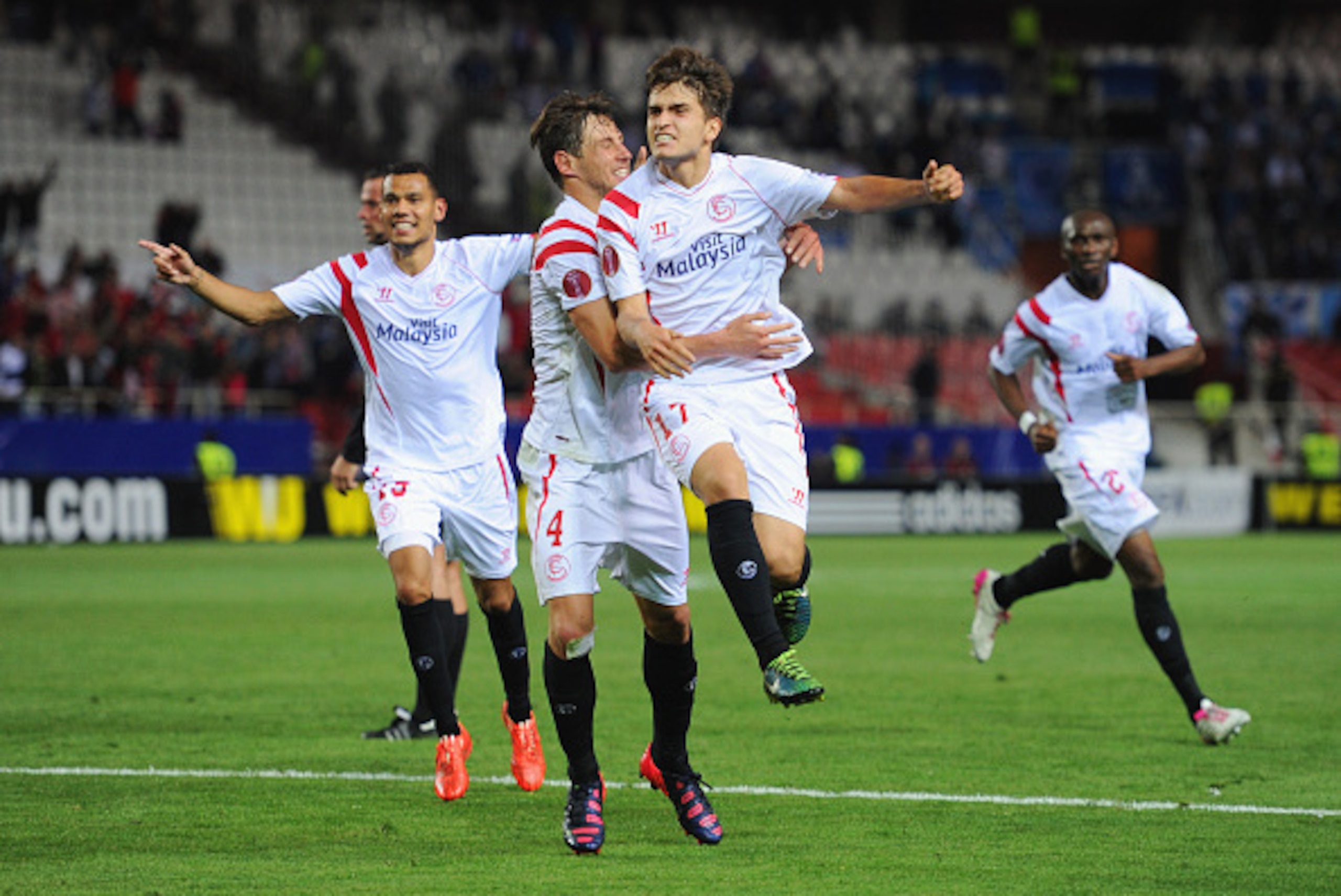SEVILLE, SPAIN - APRIL 16:  Denis Suarez of Sevilla (17) celebrates with Grzegorz Krychowiak (4) as he scores their second goal during the UEFA Europa League Quarter Final first leg match between FC Sevilla and FC Zenit at Estadio Ramon Sanchez Pizjuan on