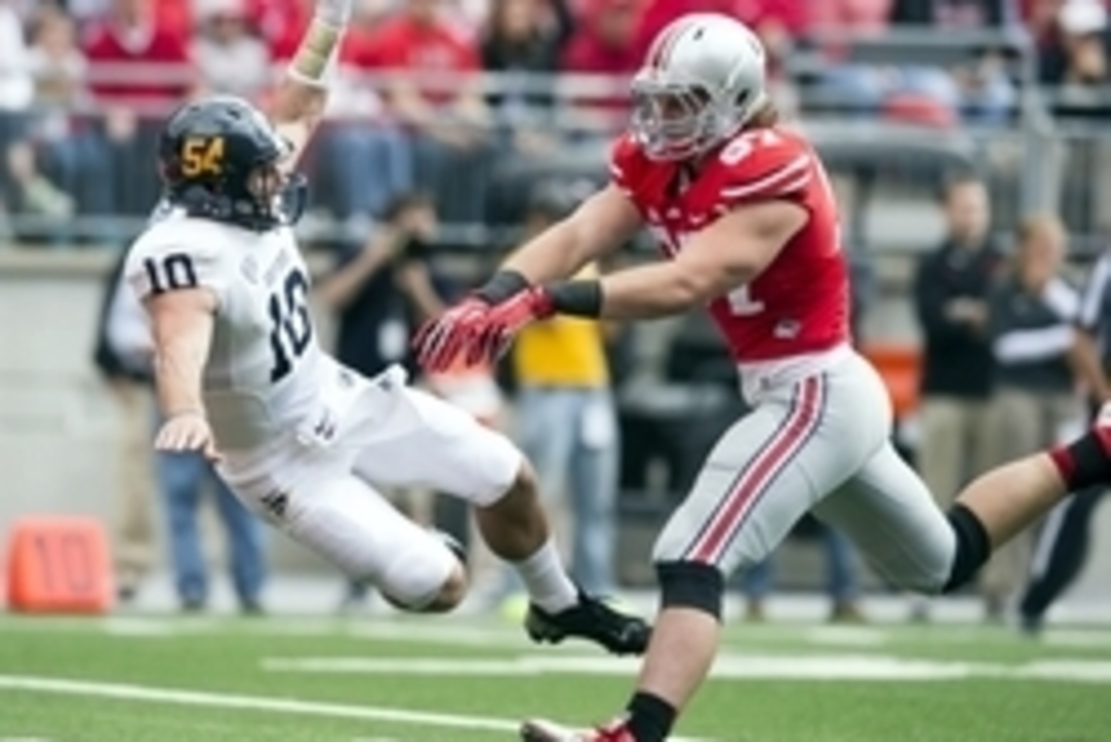 Sep 13, 2014; Columbus, OH, USA; Kent State Golden Flashes quarterback Colin Reardon (10) is knocked to the ground by Ohio State Buckeyes defensive lineman Joey Bosa (97) at Ohio Stadium. Ohio State won the game 66-0. Mandatory Credit: Greg Bartram-USA TO Sep 13, 2014; Columbus, OH, USA; Kent State Golden Flashes quarterback Colin Reardon (10) is knocked to the ground by Ohio State Buckeyes defensive lineman Joey Bosa (97) at Ohio Stadium. Ohio State won the game 66-0. Mandatory Credit: Greg Bartram-USA TO