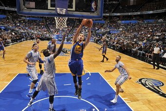 ORLANDO, FL - NOVEMBER 26:  Stephen Curry #30 of the Golden State Warriors rebounds the ball against the Orlando Magic during the game on November 26, 2014 at Amway Center in Orlando, Florida. NOTE TO USER: User expressly acknowledges and agrees that, by 