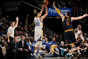 CLEVELAND, OH - FEBRUARY 26: Stephen Curry #30 of the Golden State Warriors shoots against Kevin Love #0 of the Cleveland Cavaliers at The Quicken Loans Arena on February 26, 2015 in Cleveland, Ohio. NOTE TO USER: User expressly acknowledges and agrees th