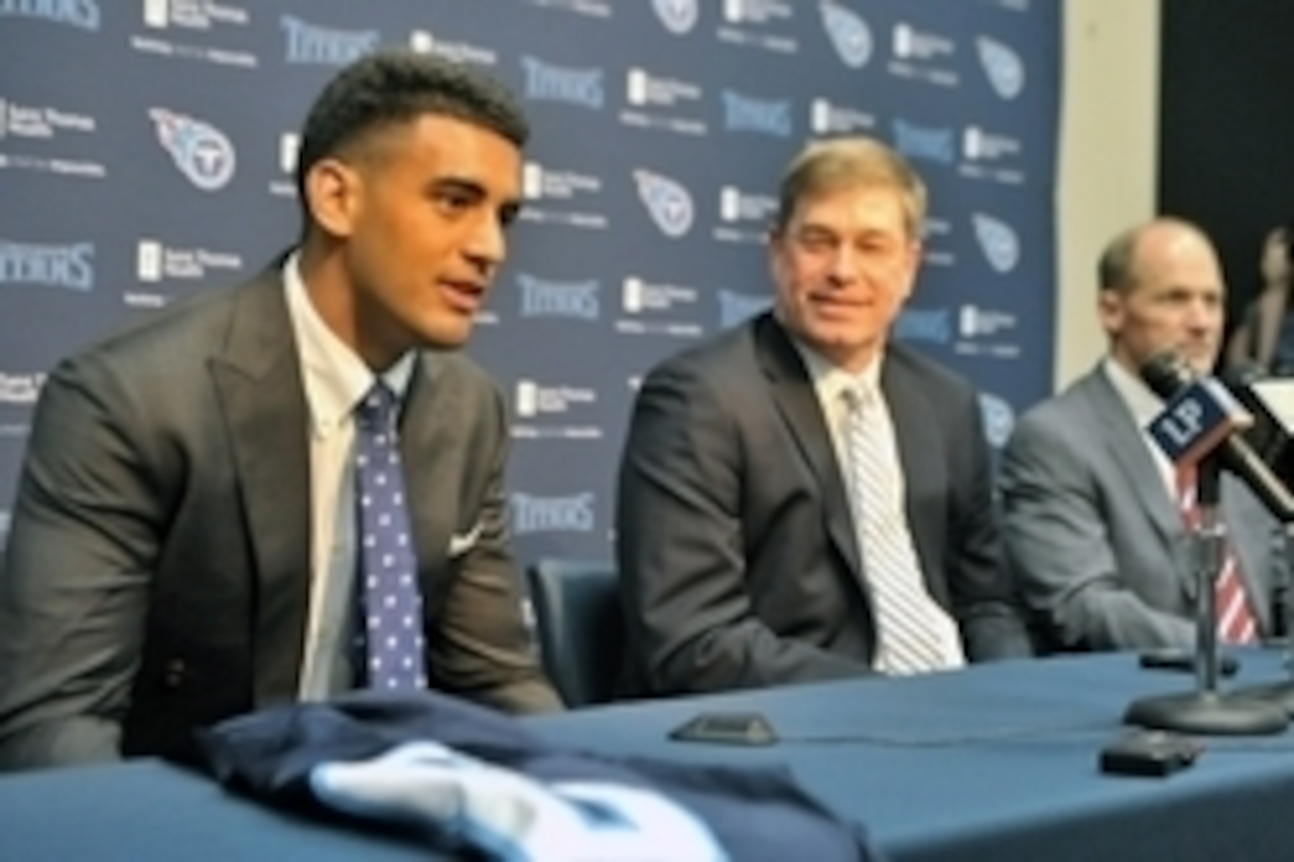 May 1, 2015; Nashville, TN, USA; Tennessee Titans first round draft pick Marcus Mariota (left) answers questions from the media as with executive vice president and general manager Ruston Webster (center) and head coach Ken Whisenhunt (right) look on duri