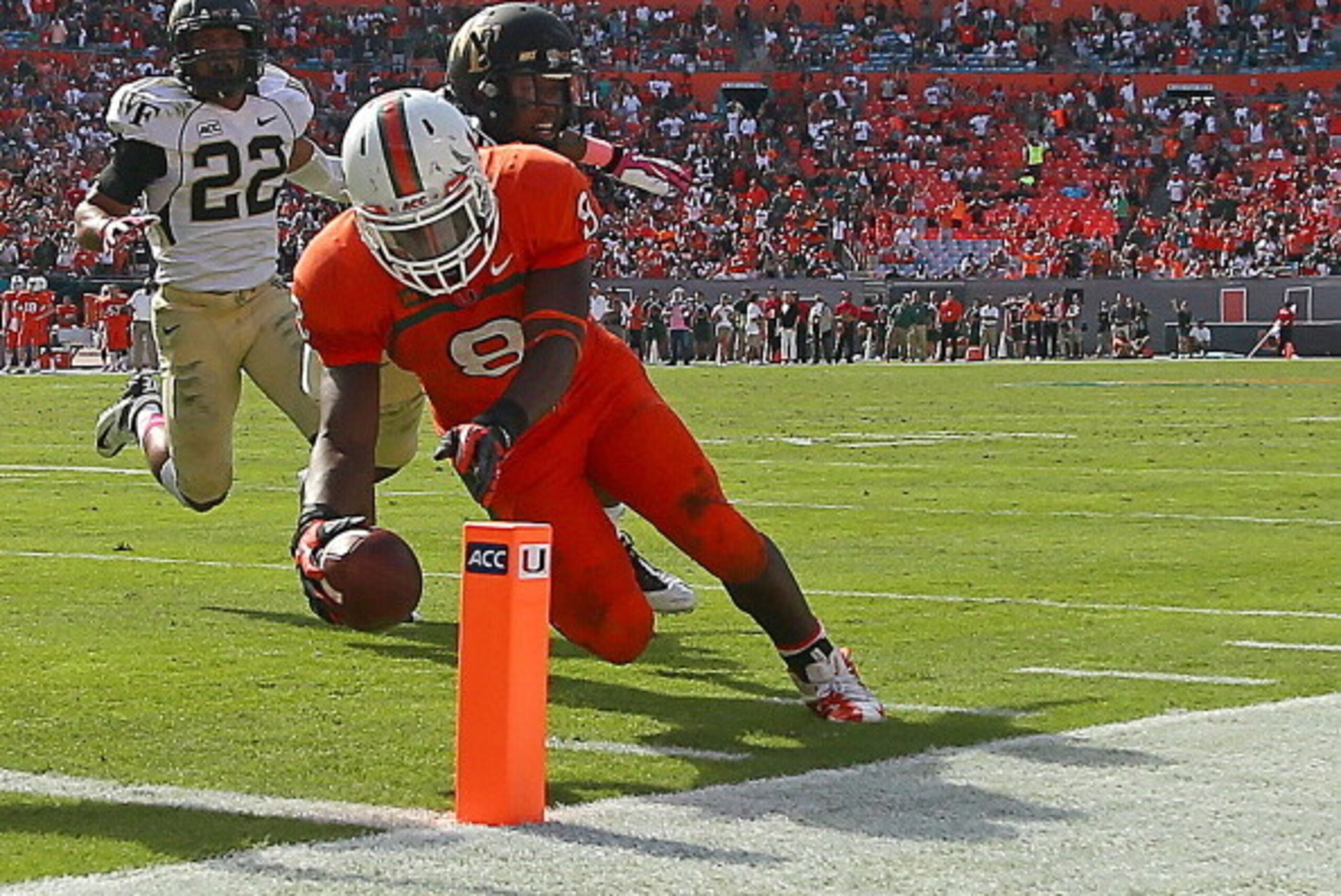 MIAMI GARDENS, FL - OCTOBER 26:  Duke Johnson #8 of the Miami Hurricanes dives for the pylon during a game against the Wake Forest Demon Deacons at Sun Life Stadium on October 26, 2013 in Miami Gardens, Florida.  (Photo by Mike Ehrmann/Getty Images)