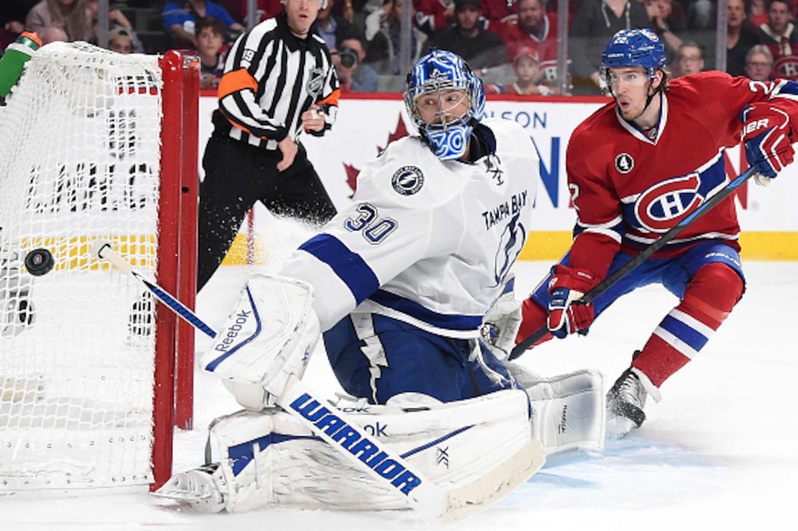 MONTREAL, QC - MAY 01: Goaltender Ben Bishop #30 of the Tampa Bay Lightning makes a blocker save against  Dale Weise #22 of the Montreal Canadiens in Game Five of the Eastern Conference Semifinals during the 2015 NHL Stanley Cup Playoffs at the Bell Centr