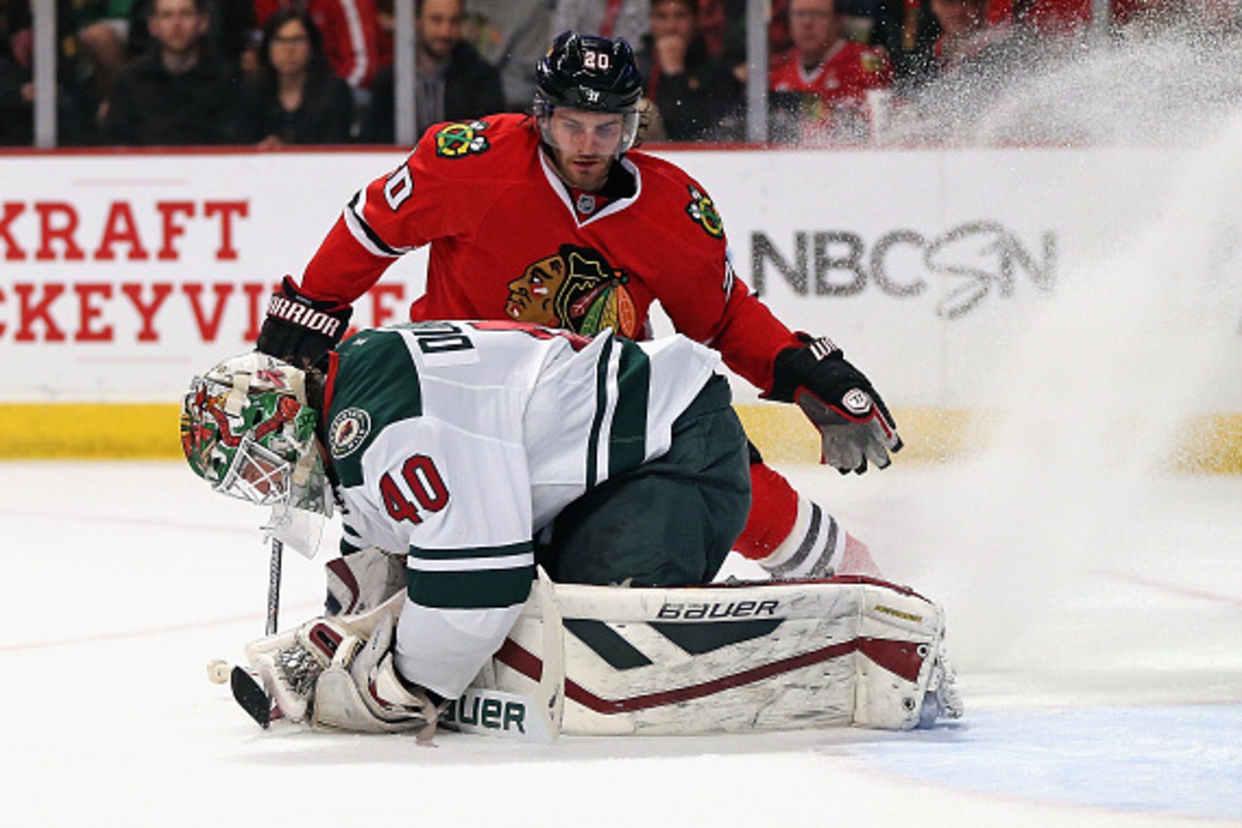 CHICAGO, IL - MAY 01: Devan Dubnyk #40 of the Minnesota Wild smothers the puck as Brandon Saad #20 of the Chicago Blackhawks closes in during Game One of the Western Conference Semifinals during the 2015 NHL Stanley Cup Playoffs at the United Center on Ma