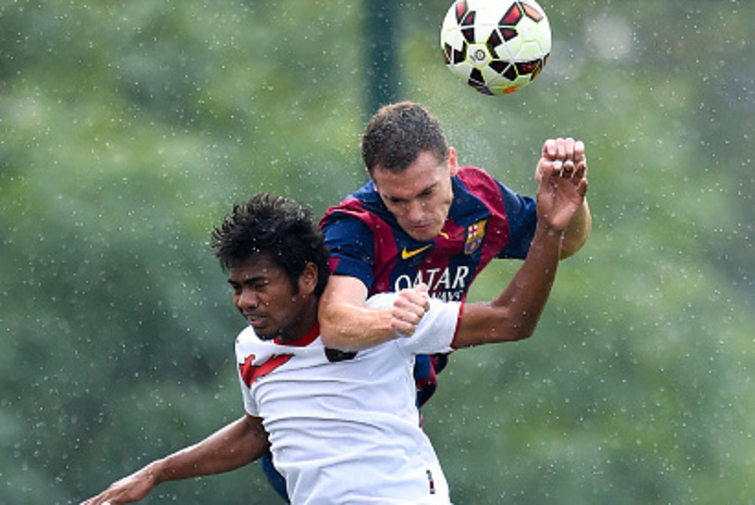 BARCELONA, SPAIN - SEPTEMBER 24:  Thomas Vermaelen of FC Barcelona duels for a high ball with Ulham Udin of Indonesia U19 during a friendly match between FC Barcelona B and Indonesia U19 at Ciutat Esportiva on September 24, 2014 in Barcelona, Spain.  (Pho