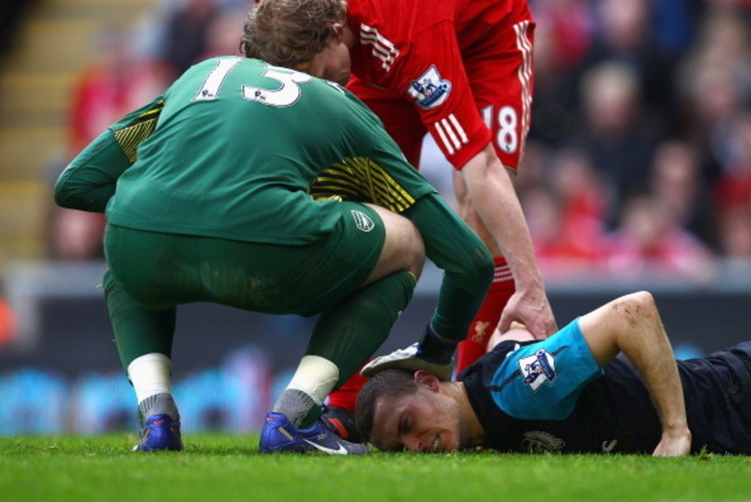 LIVERPOOL, ENGLAND - MARCH 03:  Thomas Vermaelen of Arsenal lies injured on the pitch during the Barclays Premier League match between Liverpool and Arsenal at Anfield on March 3, 2012 in Liverpool, England.  (Photo by Clive Mason/Getty Images)