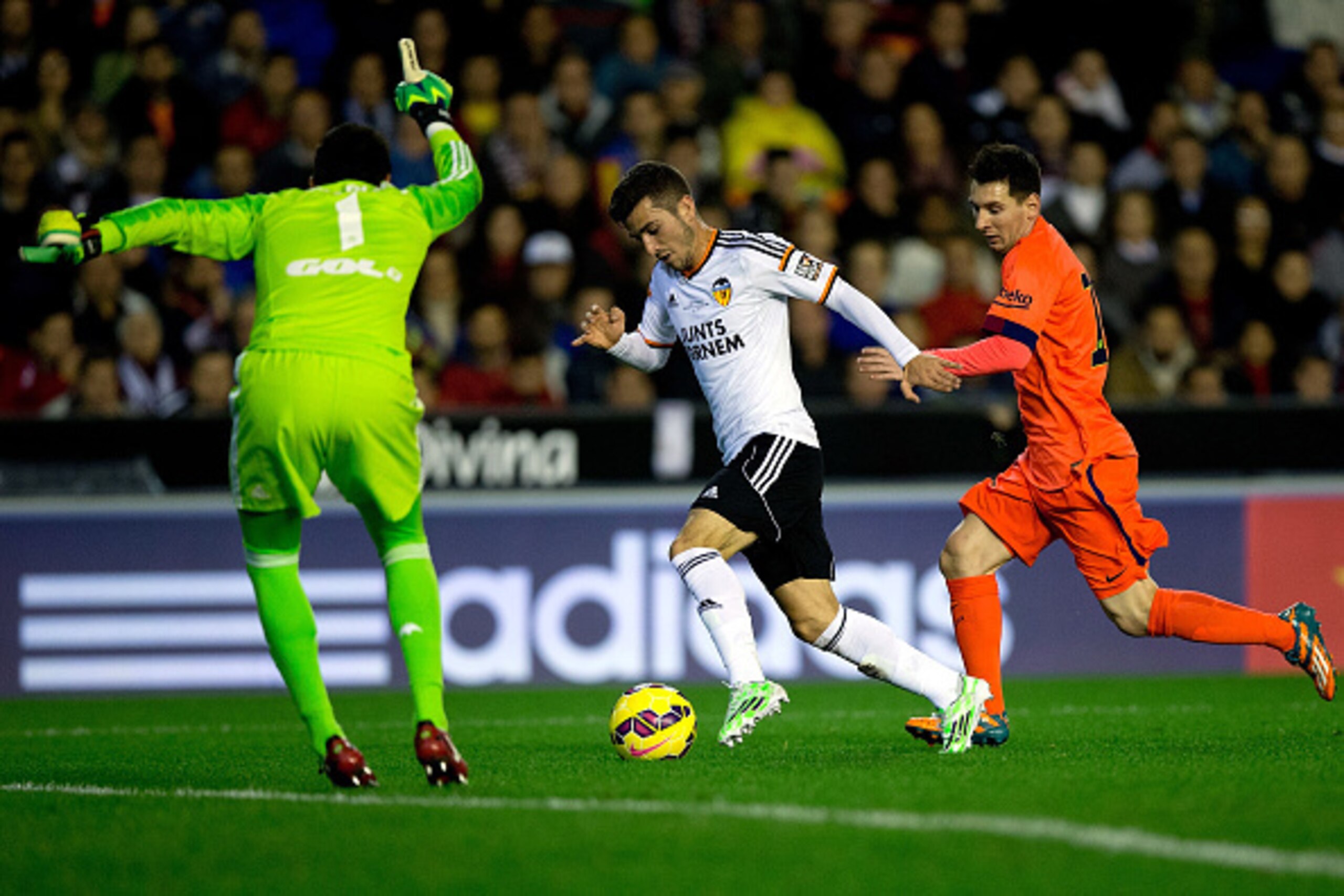 VALENCIA, SPAIN - NOVEMBER 30: Lionel Messi (R) of FC Barcelona competes for the ball with Jose Gaya (2ndR) as his goalkeeper Diego Alves gives instructions to him during the La Liga match between Valencia CF and FC Barcelona at Estadi de Mestalla on Nove