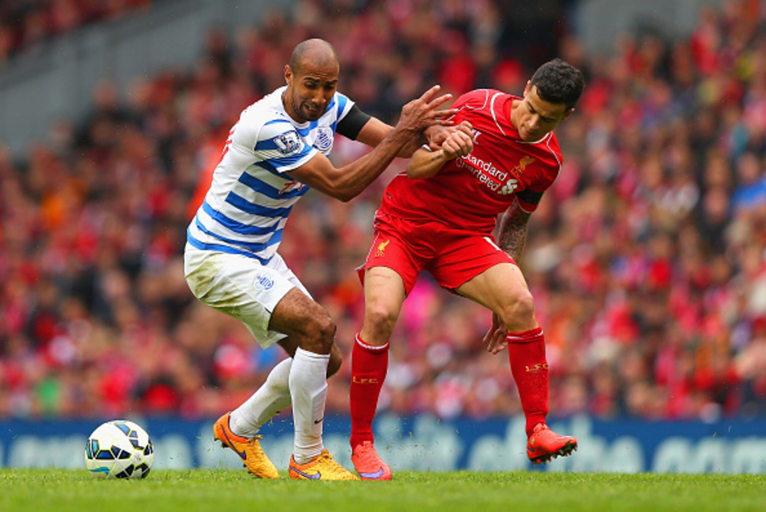 LIVERPOOL, ENGLAND - MAY 02:  Philippe Coutinho of Liverpool is challenged by Karl Henry of QPR during the Barclays Premier League match between Liverpool and Queens Park Rangers at Anfield on May 2, 2015 in Liverpool, England.  (Photo by Alex Livesey/Get