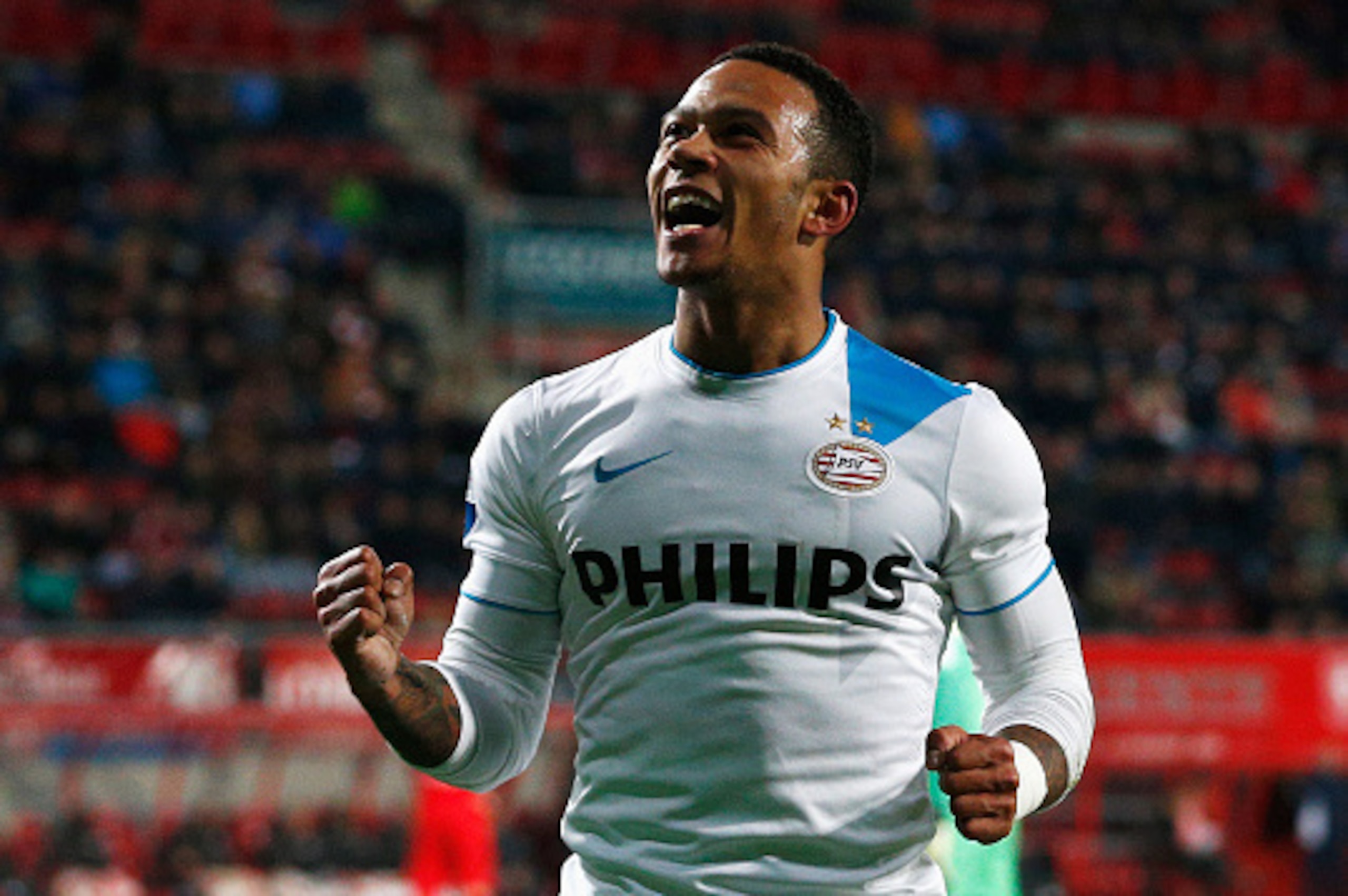 ENSCHEDE, NETHERLANDS - APRIL 04:  Memphis Depay of PSV celebrates after he scores the fifth goal of the game for his team during the Dutch Eredivisie match between FC Twente and PSV Eindhoven held at De Grolsch Veste Stadium on April 4, 2015 in Enschede,