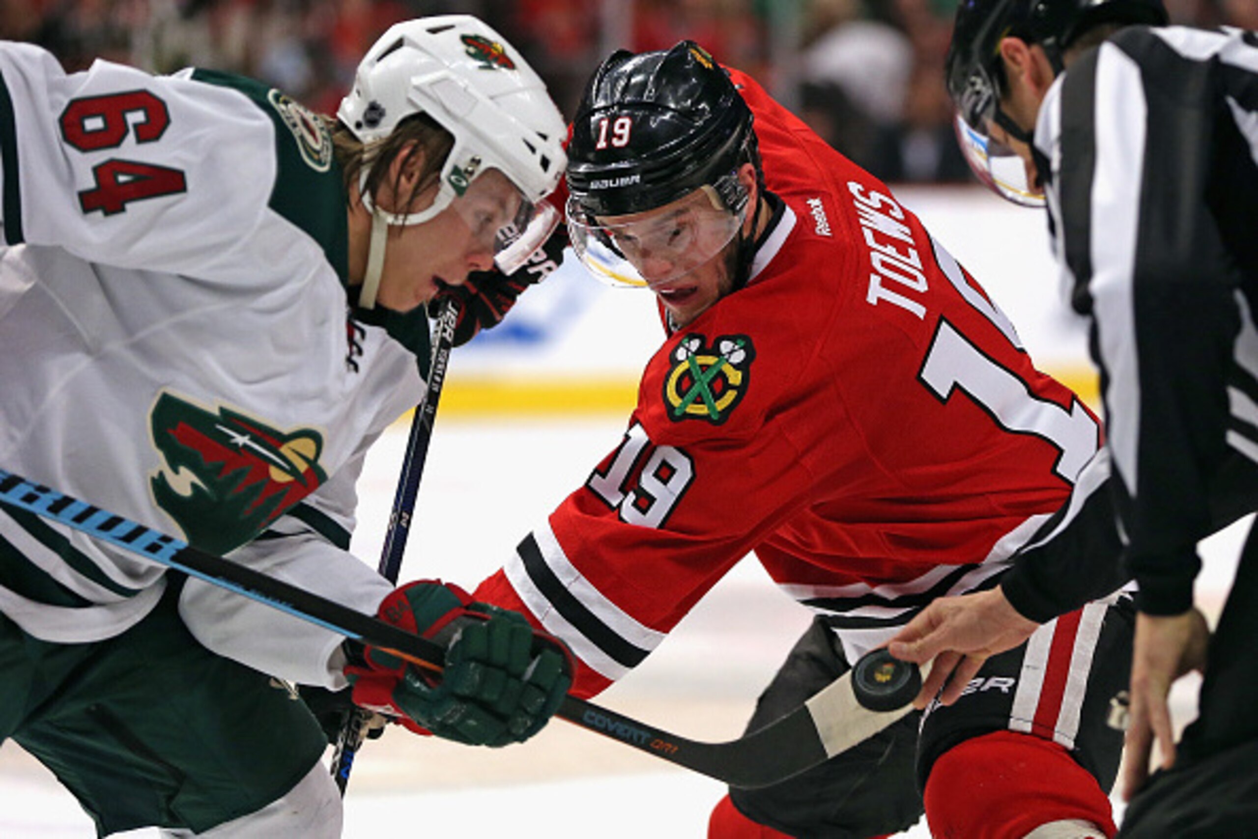 CHICAGO, IL - MAY 01: Jonathan Toews #19 of the Chicago Blackhawks and Mikael Granlund #64 of the Minnesota Wild wait for the referee to drop the puck on a face-off in Game One of the Western Conference Semifinals during the 2015 NHL Stanley Cup Playoffs 