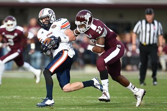 STARKVILLE, MS - NOVEMBER 08:  William Tanner #8 of the Tennessee Martin Skyhawks catches a pass in front of Matthew Wells #22 of the Mississippi State Bulldogs during the second quarter of a game at Davis Wade Stadium on November 8, 2014 in Starkville, M