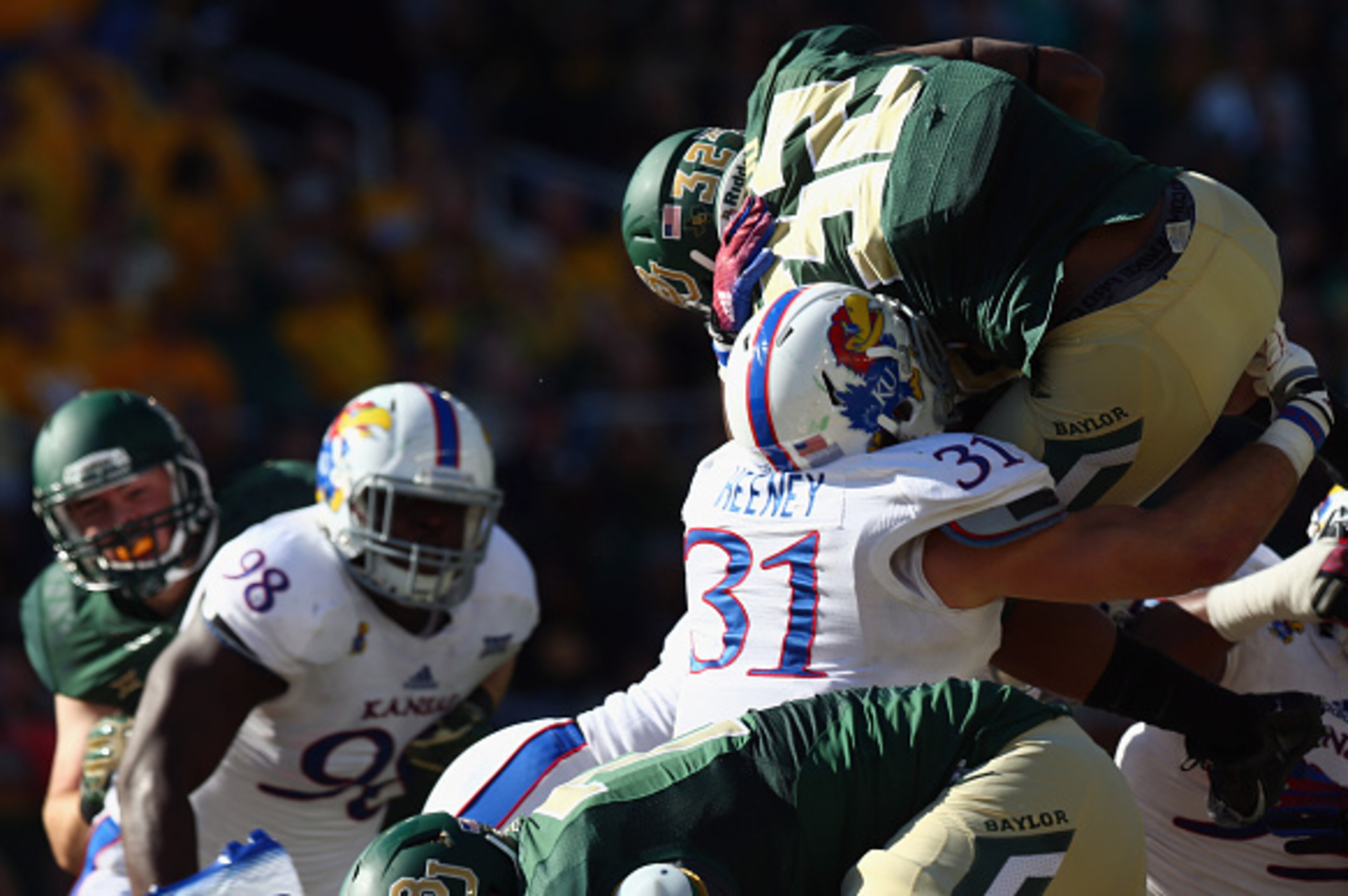 WACO, TX - NOVEMBER 01:  Shock Linwood #32 of the Baylor Bears jumps for the touchdown against Ben Heeney #31 of the Kansas Jayhawks at McLane Stadium on November 1, 2014 in Waco, Texas.  (Photo by Ronald Martinez/Getty Images)