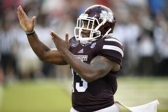Oct 11, 2014; Starkville, MS, USA; Mississippi State Bulldogs running back Josh Robinson (13) gestures to the crowd as he celebrates his touchdown against the Auburn Tigers during the fourth quarter at Davis Wade Stadium. Mandatory Credit: John David Merc