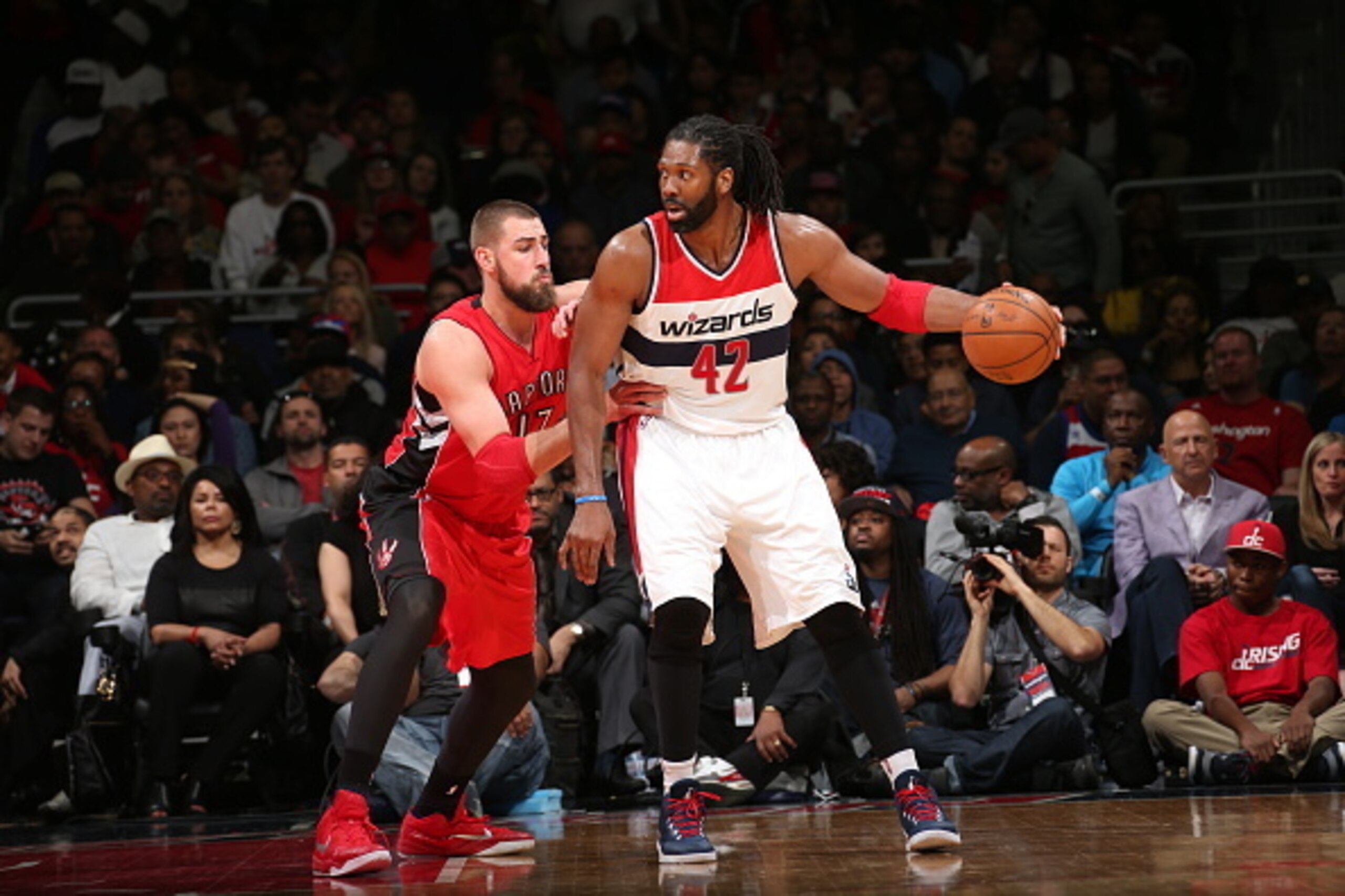 WASHINGTON, DC - APRIL 26:  Nene Hilario #42 of the Washington Wizards handles the ball against Jonas Valanciunas #17 of the Toronto Raptors in Game Four of the Eastern Conference Quarterfinals during the 2015 NBA Playoffs on April 26, 2015 at the Verizon