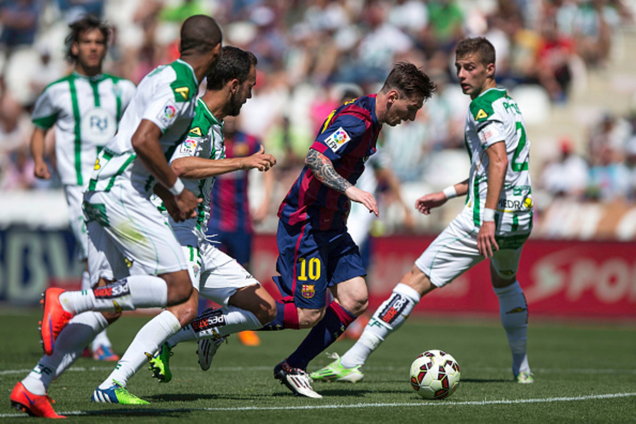 CORDOBA, SPAIN - MAY 02: Lionel Messi (2ndR) of FC Barcelona competes for the ball with Aleksandar Pantic (R) of Cordoba CF during the La Liga match between Cordoba CF and Barcelona FC at El Arcangel stadium on May 2, 2015 in Cordoba, Spain.  (Photo by Go