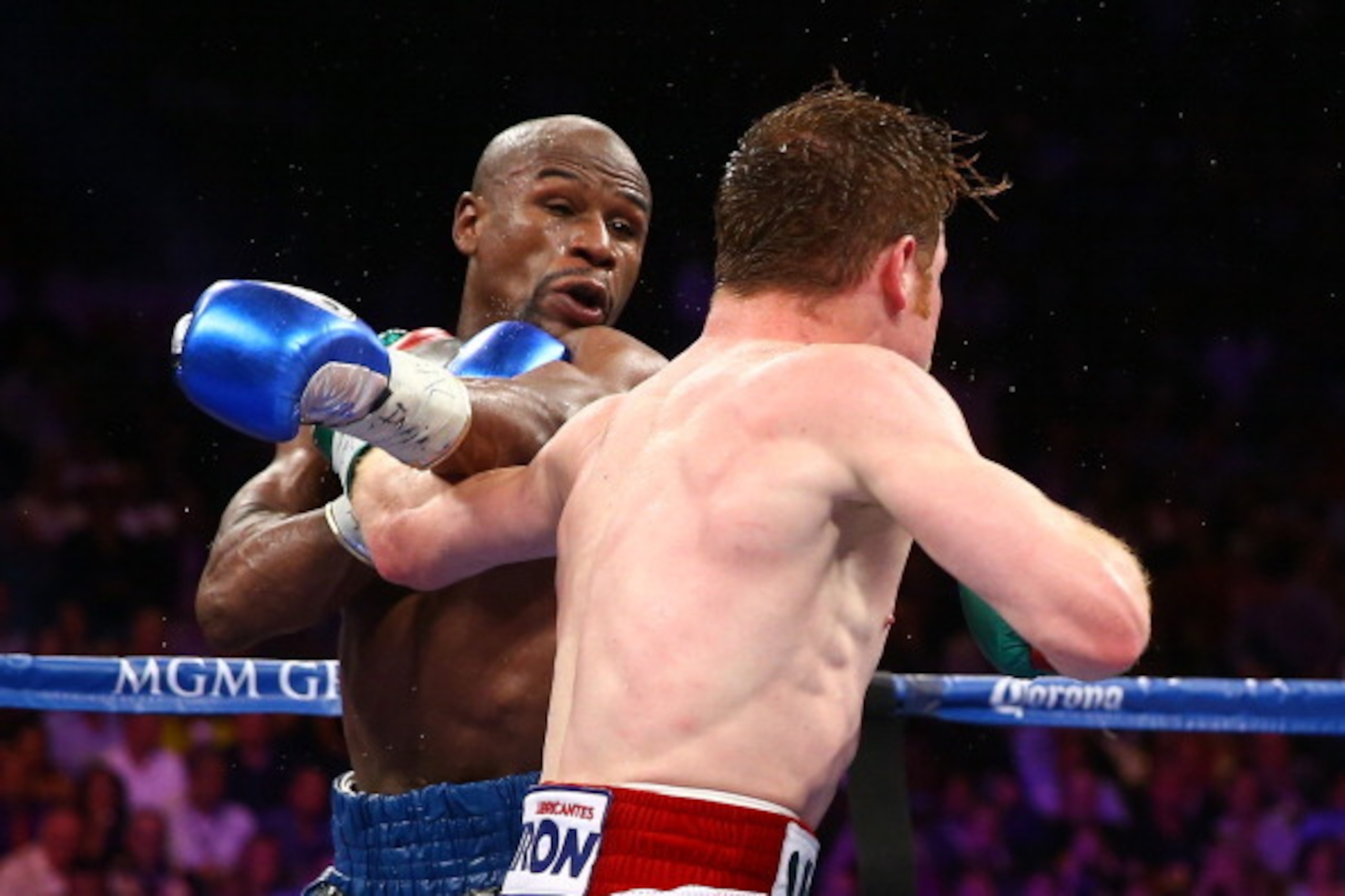 LAS VEGAS, NV - SEPTEMBER 14:  (L-R) Floyd Mayweather Jr. throws a left at Canelo Alvarez during their WBC/WBA 154-pound title fight at the MGM Grand Garden Arena on September 14, 2013 in Las Vegas, Nevada.  (Photo by Al Bello/Getty Images)