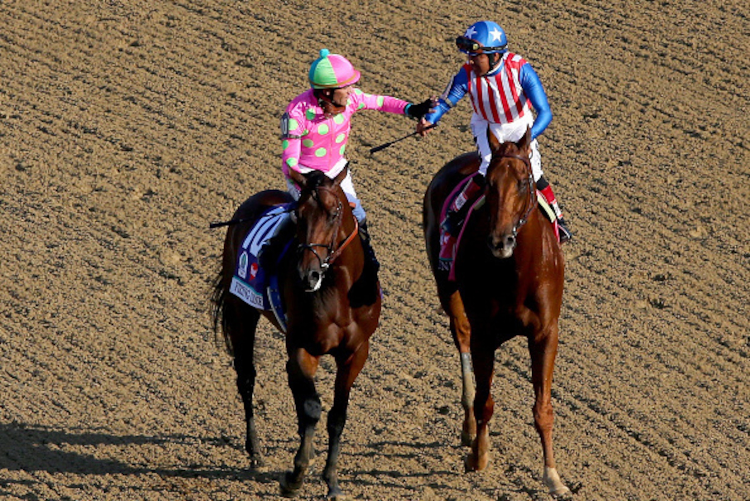 LOUISVILLE, KY - MAY 02: Jockey Gary Stevens, atop Firing Line #10, celebrates placing with Martin Garcia, atop Dortmund #8, during the 141st running of the Kentucky Derby at Churchill Downs on May 2, 2015 in Louisville, Kentucky. (Photo by Elsa/Getty I LOUISVILLE, KY - MAY 02: Jockey Gary Stevens, atop Firing Line #10, celebrates placing with Martin Garcia, atop Dortmund #8, during the 141st running of the Kentucky Derby at Churchill Downs on May 2, 2015 in Louisville, Kentucky. (Photo by Elsa/Getty I