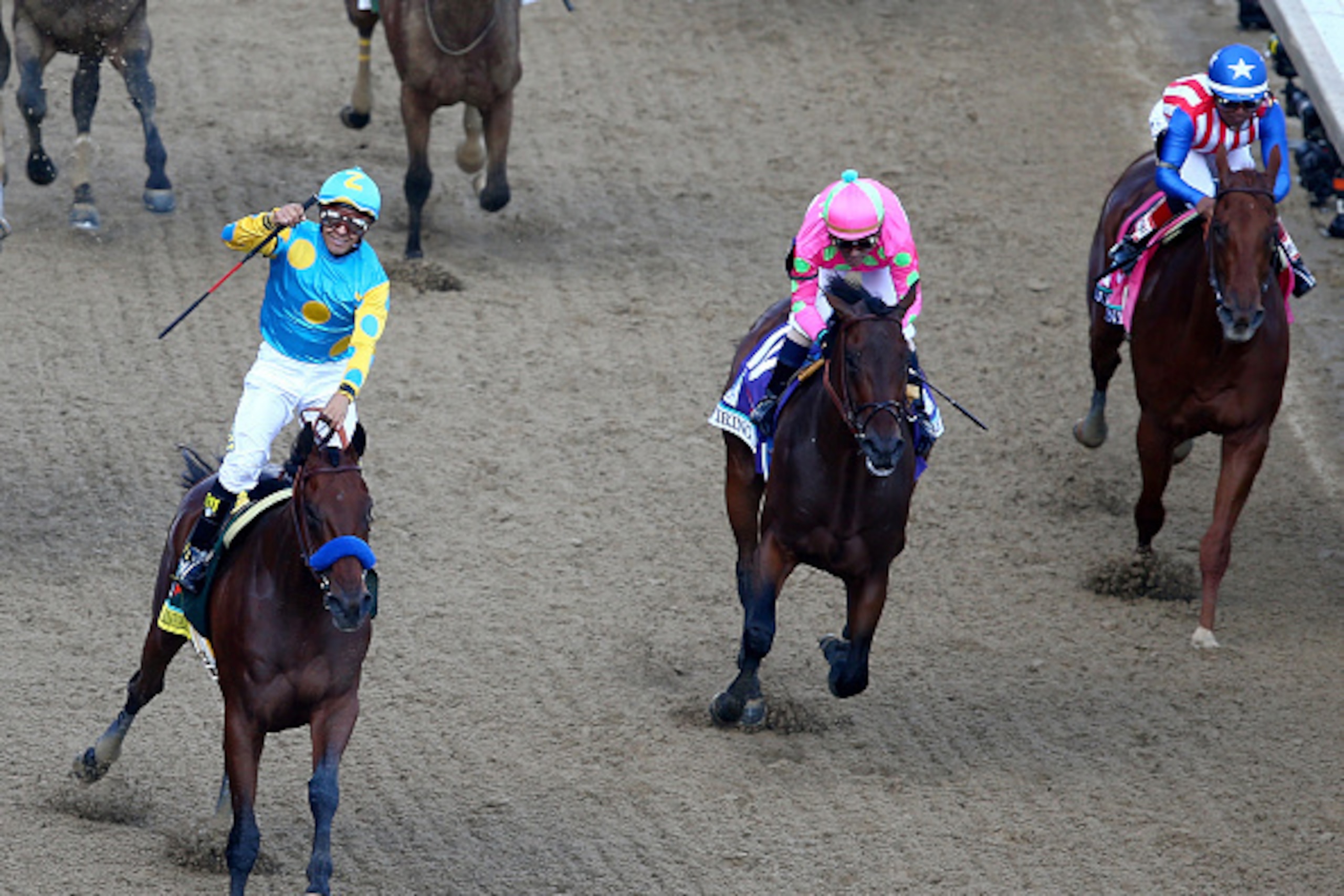 LOUISVILLE, KY - MAY 02: Jockey Victor Espinoza celebrates as he guides American Pharoah #18 after he crossed the finish line as Firing Line #10, ridden by Gary Stevens, and Dortmund #8, ridden by Martin Garcia, fiinish second and third during the 141st LOUISVILLE, KY - MAY 02: Jockey Victor Espinoza celebrates as he guides American Pharoah #18 after he crossed the finish line as Firing Line #10, ridden by Gary Stevens, and Dortmund #8, ridden by Martin Garcia, fiinish second and third during the 141st
