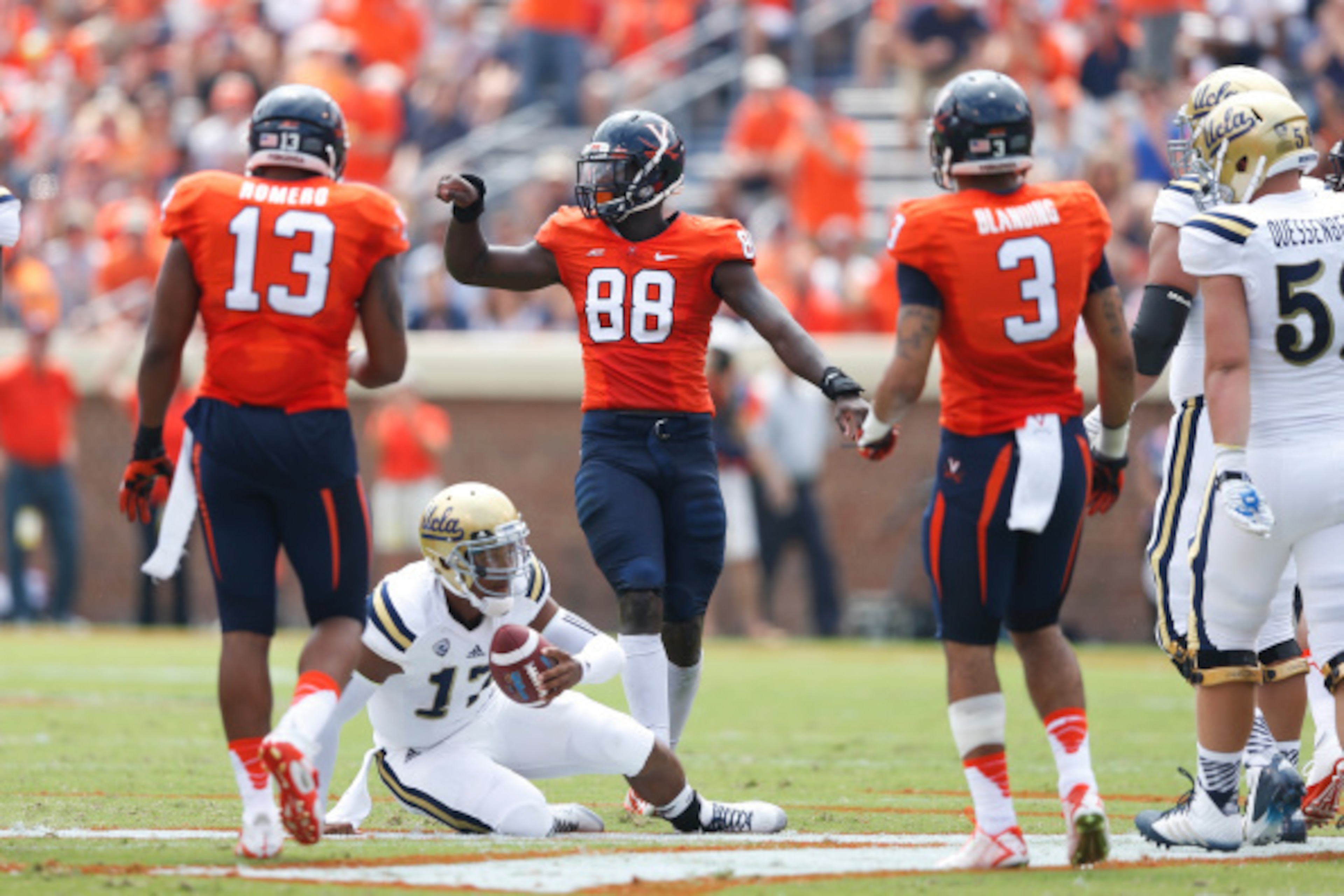 CHARLOTTESVILLE, VA - AUGUST 30: Brett Hundley #17 of the UCLA Bruins gets up after being sacked by Max Valles #88 of the Virginia Cavaliers during first half action at Scott Stadium on August 30, 2014 in Charlottesville, Virginia. (Photo by Joe Robbins/G