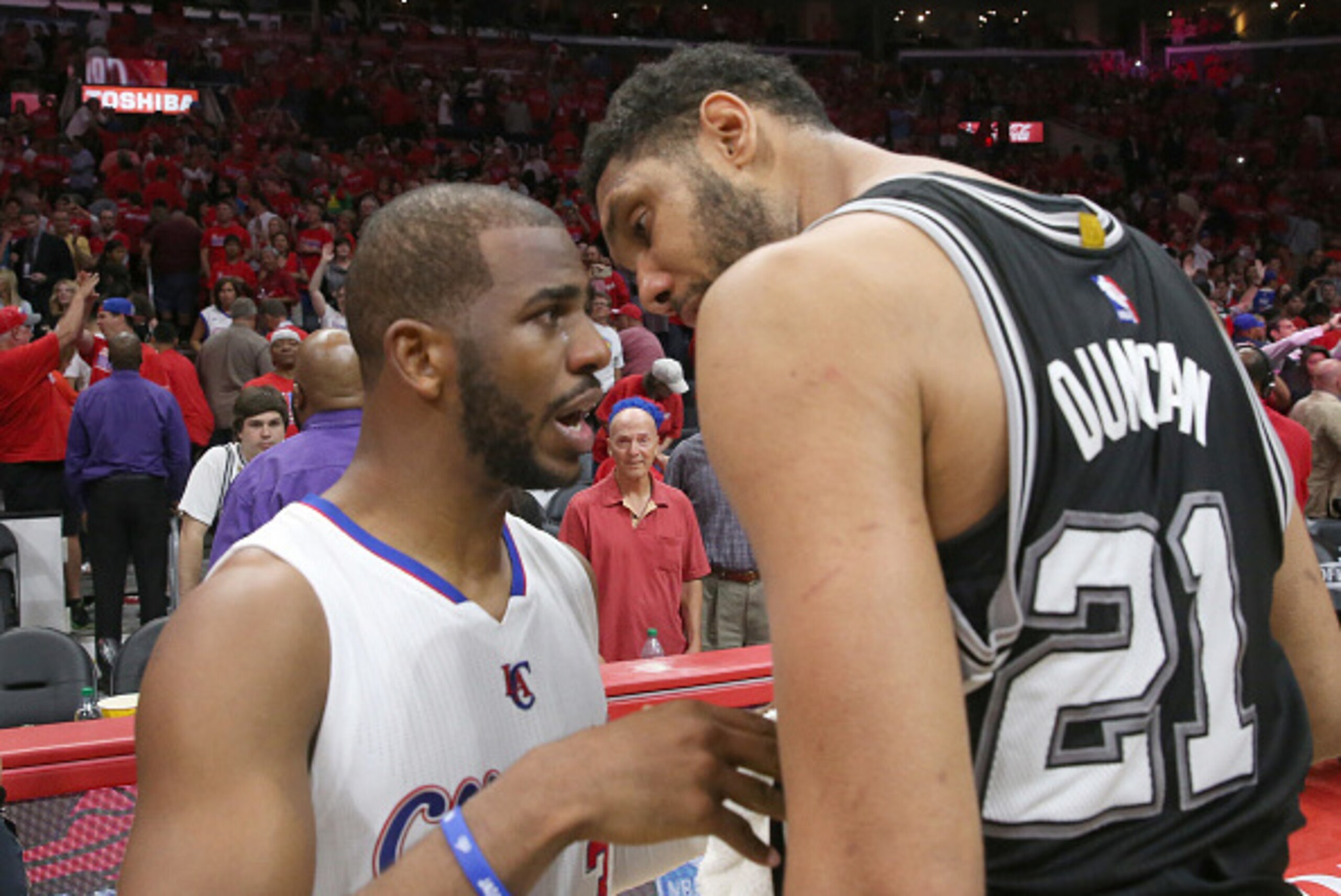 LOS ANGELES, CA - MAY 02:  Tim Duncan #21 of the San Antonio Spurs and Chris Paul #3 of the Los Angeles Clippers meet after Game Seven of the Western Conference quarterfinals of the 2015 NBA Playoffs at Staples Center on May 2, 2015 in Los Angeles, Califo