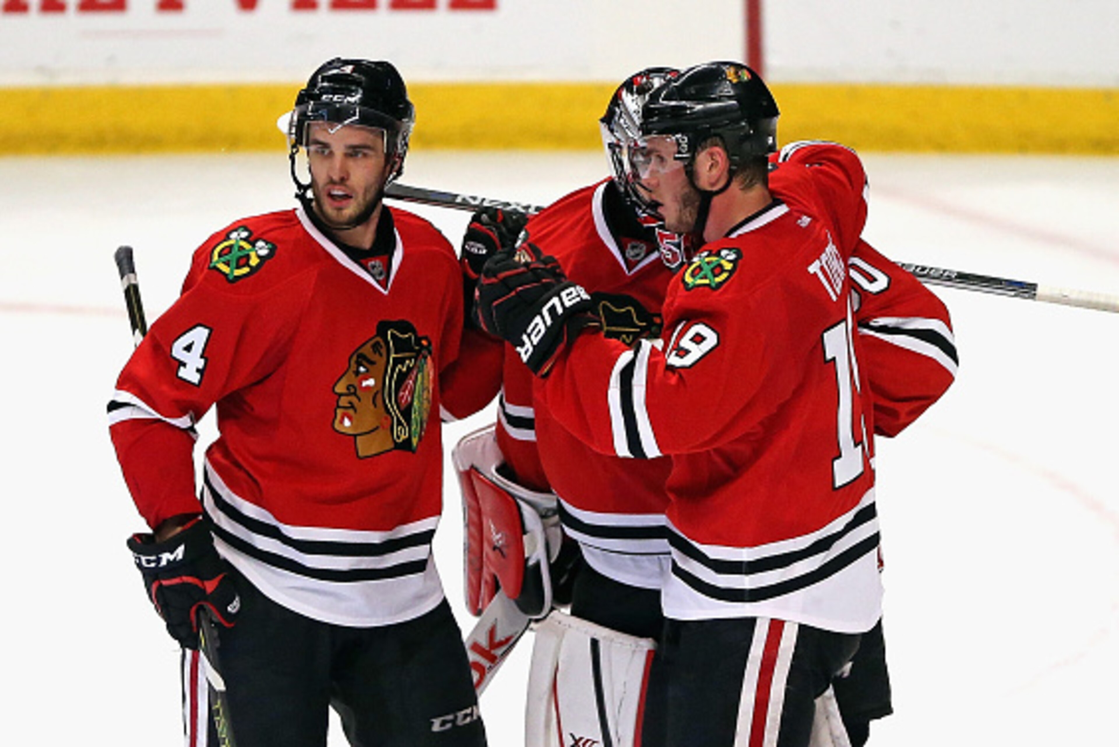 CHICAGO, IL - MAY 01: (L-R) Niklas Hjalmarsson #4, Corey Crawford #50 and Jonathan Toews #19 of the Chicago Blackhawks celebrate a win over the Minnesota Wild in Game One of the Western Conference Semifinals during the 2015 NHL Stanley Cup Playoffs at the
