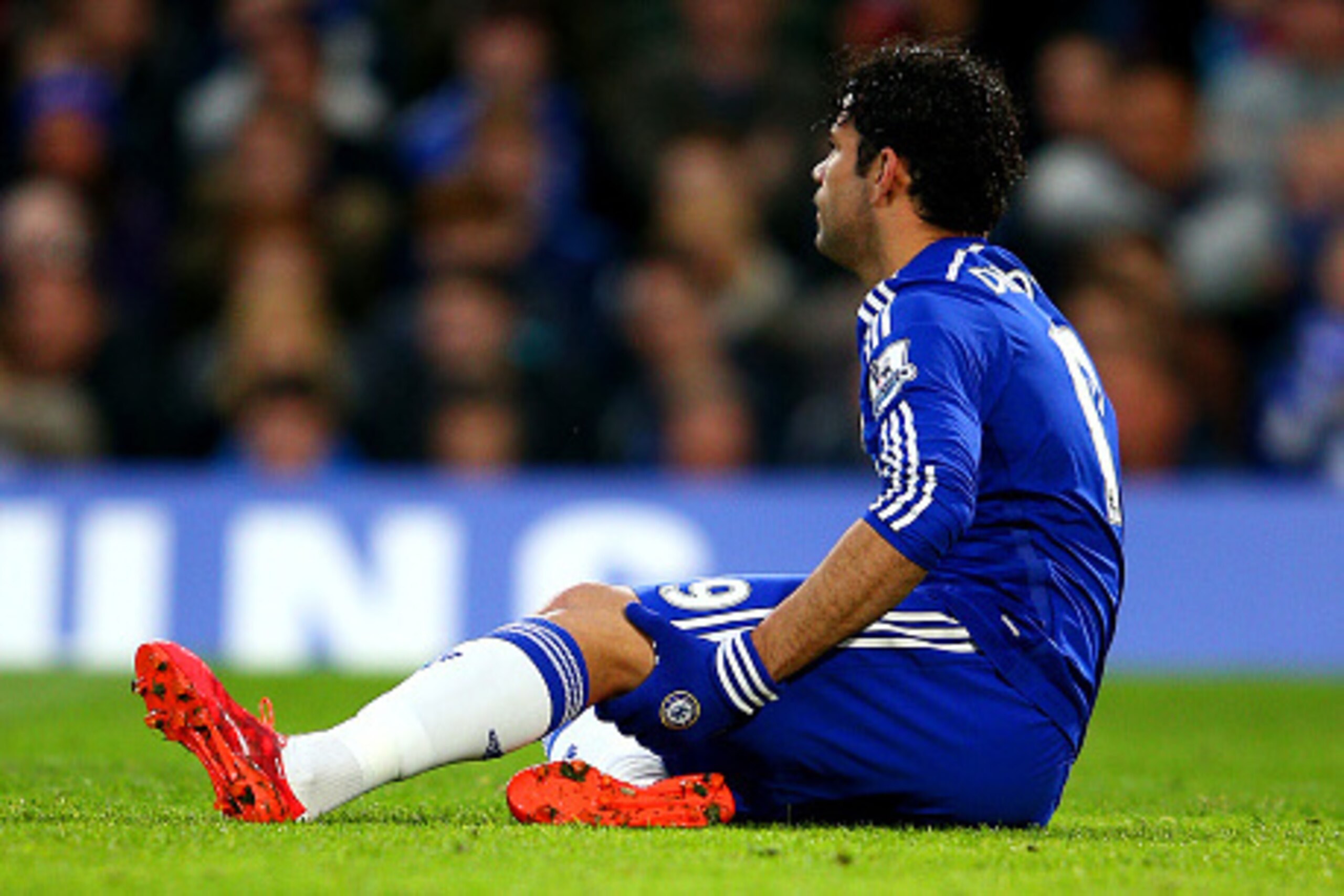 LONDON, ENGLAND - APRIL 04:  Diego Costa of Chelsea holds his leg as he sits on the turf before leaving the pitch injured during the Barclays Premier League match between Chelsea and Stoke City at Stamford Bridge on April 4, 2015 in London, England.  (Pho