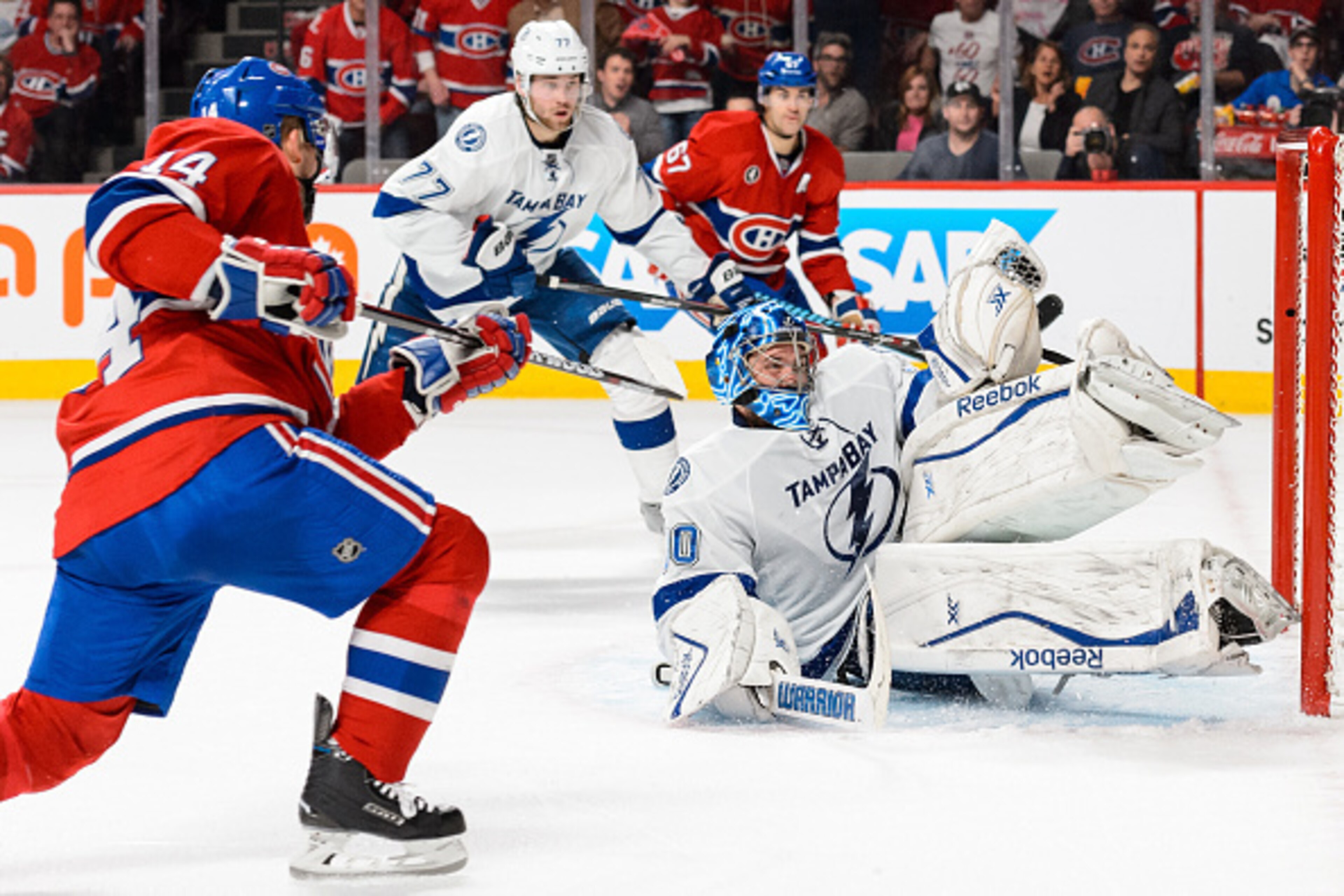 MONTREAL, QC - MAY 01:  Goaltender Ben Bishop #30 of the Tampa Bay Lightning makes a glove save on Tomas Plekanec #14 of the Montreal Canadiens in Game One of the Eastern Conference Semifinals during the 2015 NHL Stanley Cup Playoffs at the Bell Centre on